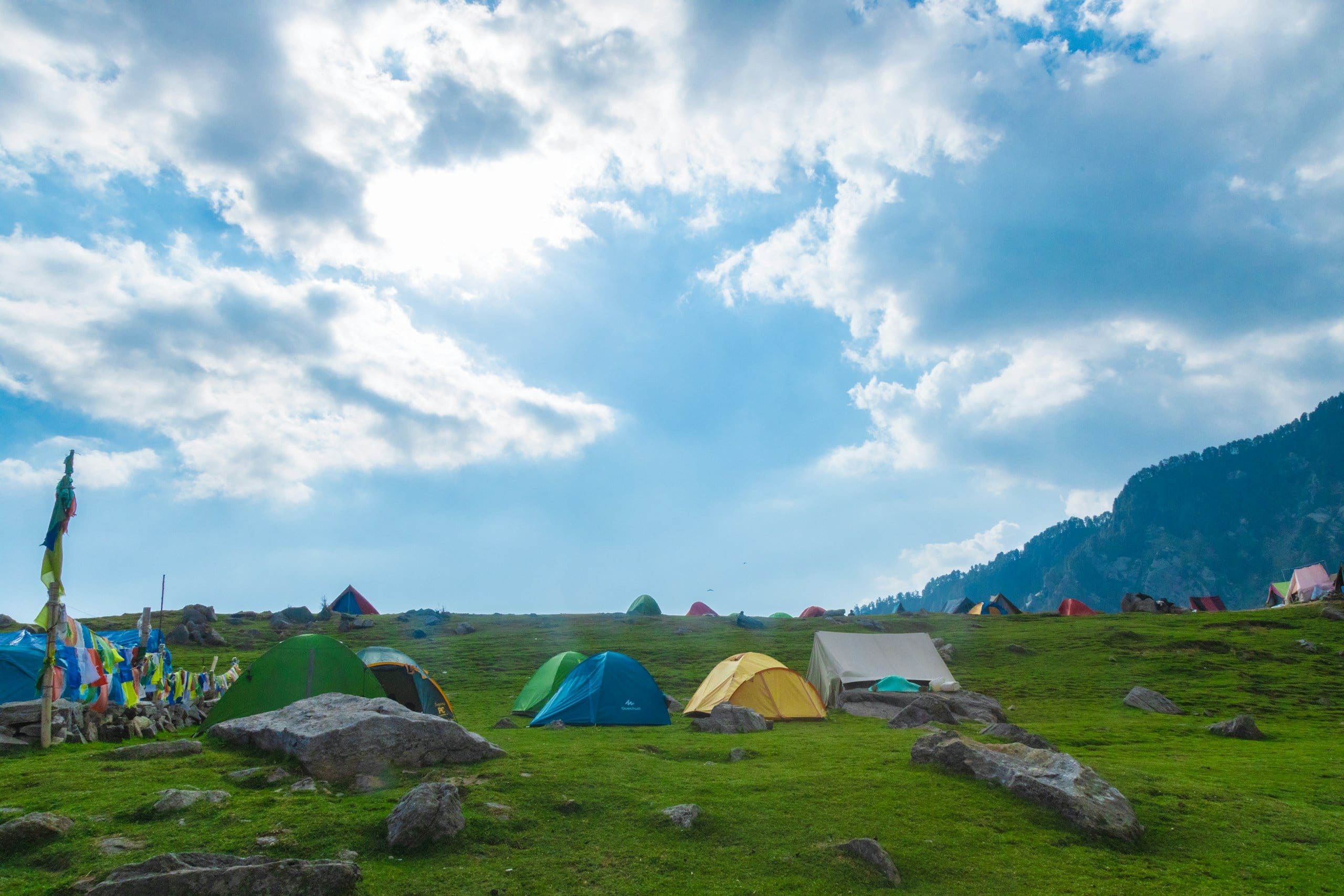 a group of tents sitting on top of a lush green field