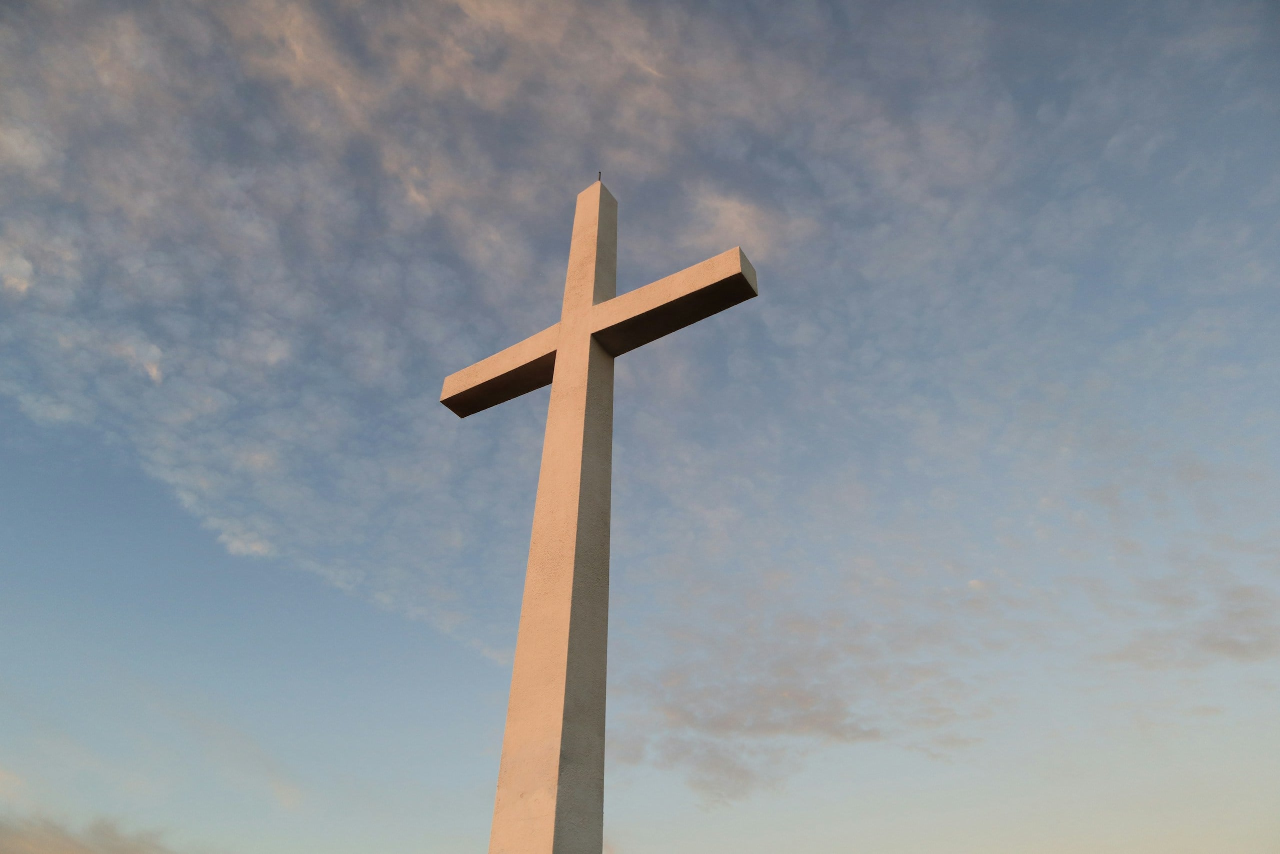 white cross under blue sky during daytime