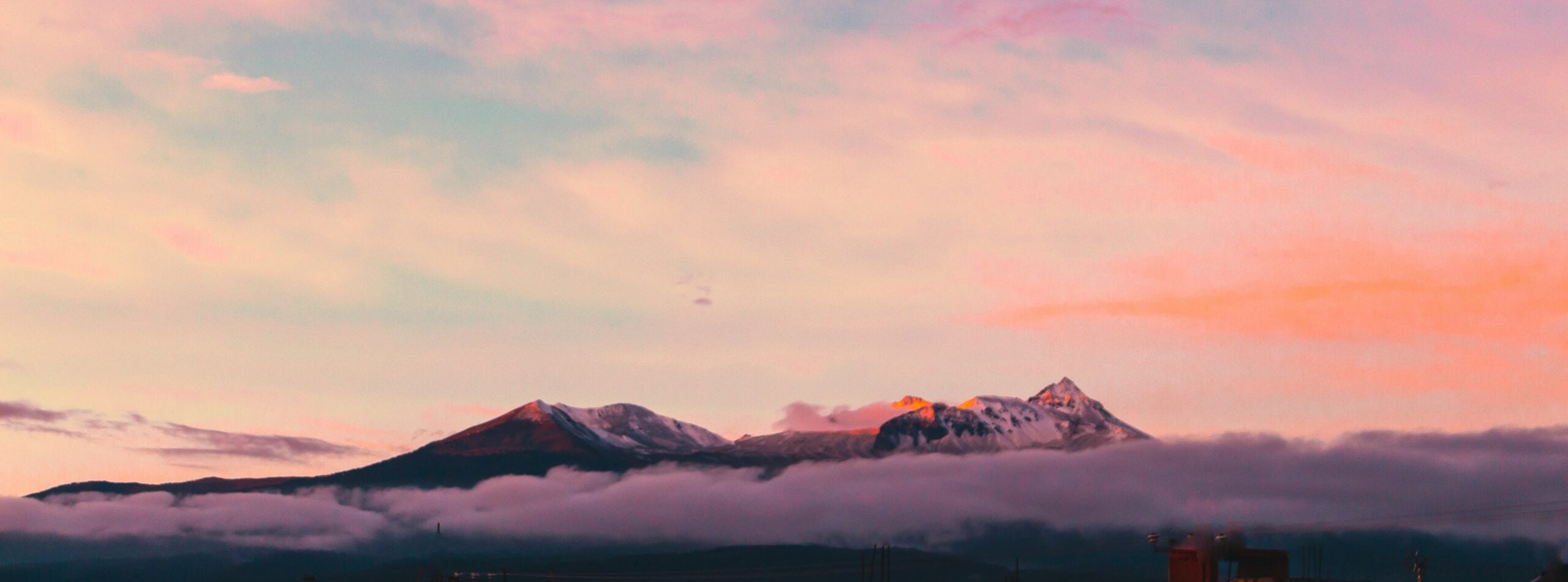 aerial photography of mountain under clouds during golden hour