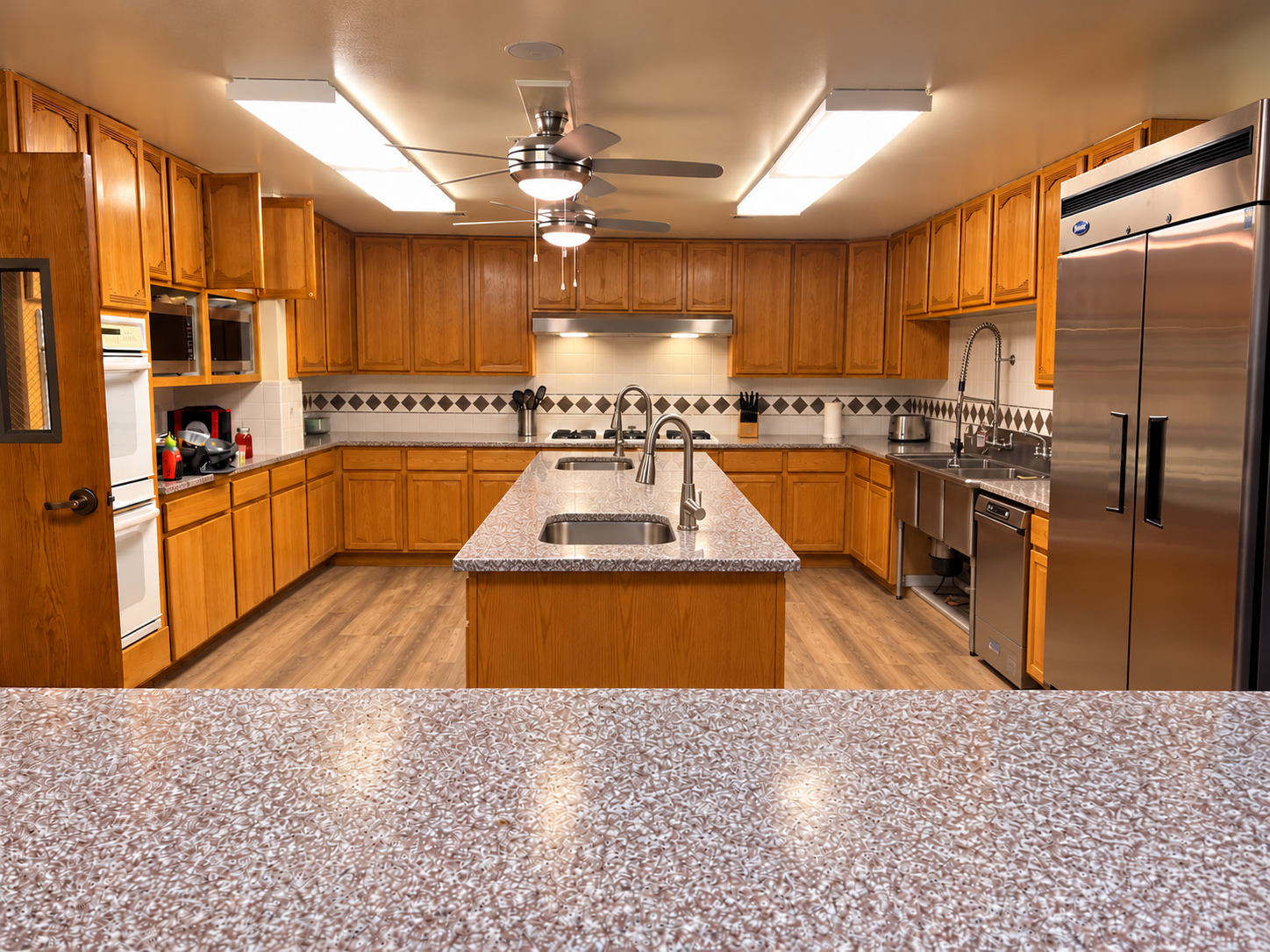 All Nations Center kitchen with twin island sinks and a stainless wash station