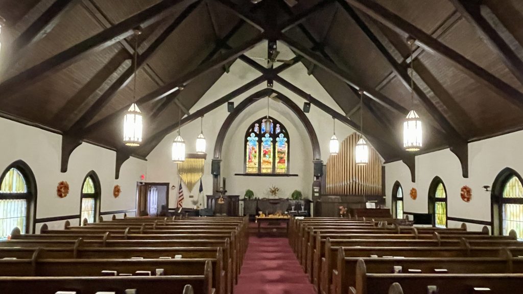 Sanctuary of Amesbury Seventh-day Adventist Church with stained glass window