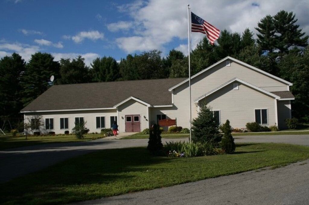 Amesbury Adventist School building with American flag