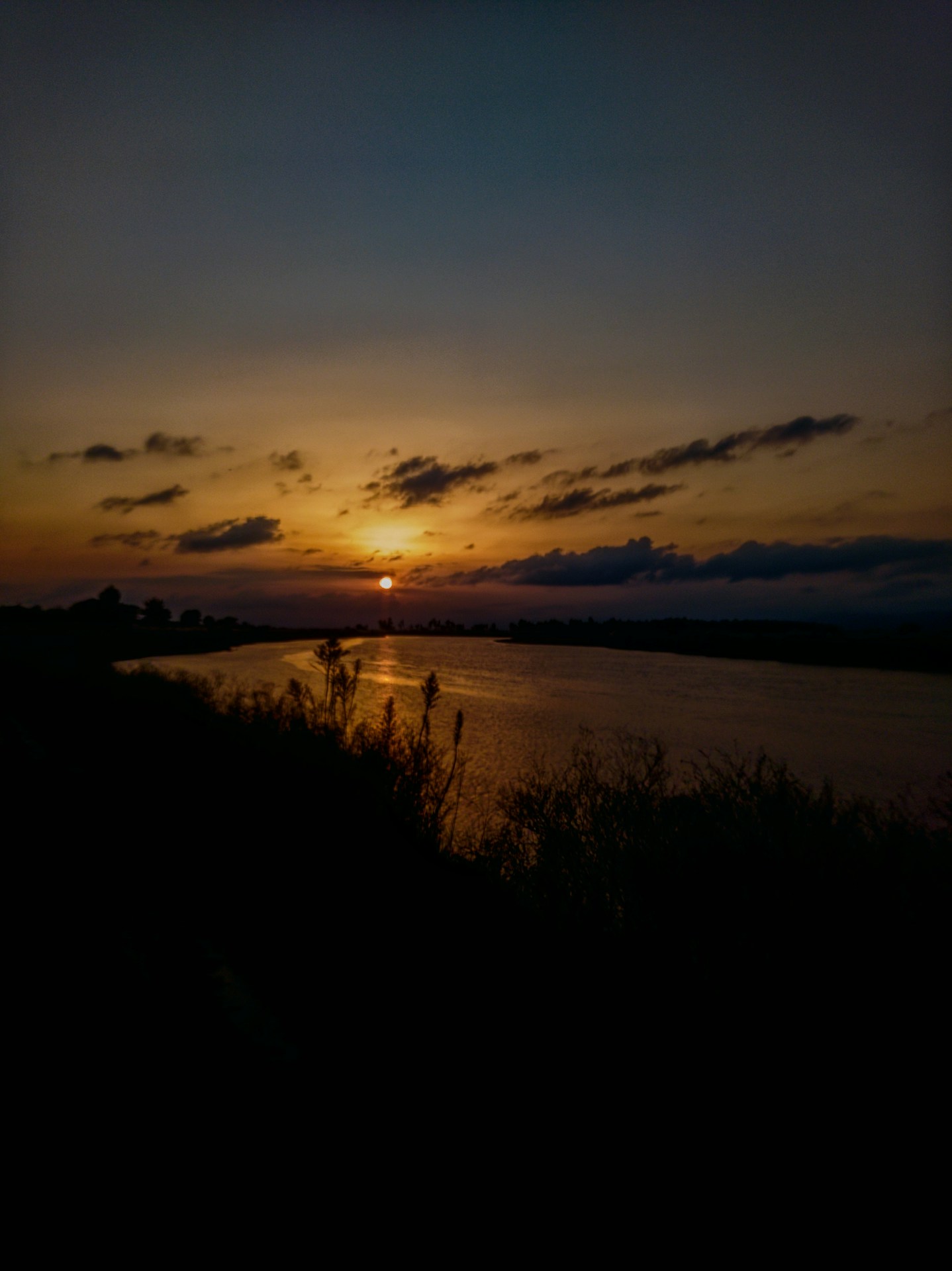 the sun is setting over a body of water