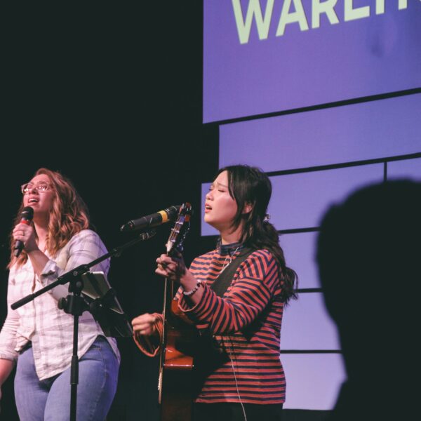 photography of two singing women