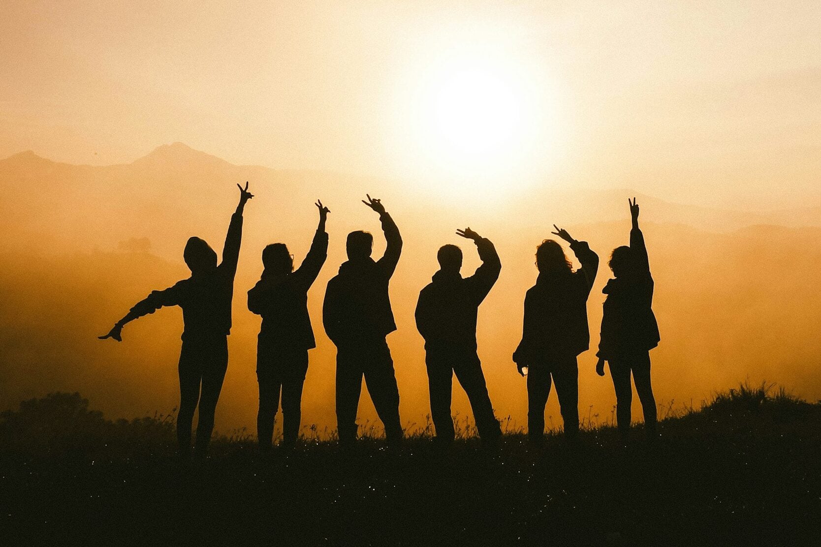 silhouette photo of six persons on top of mountain
