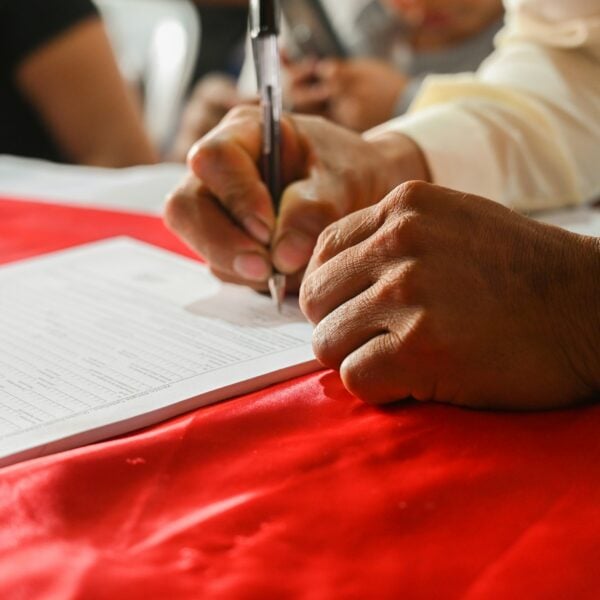 a person writing on a piece of paper
