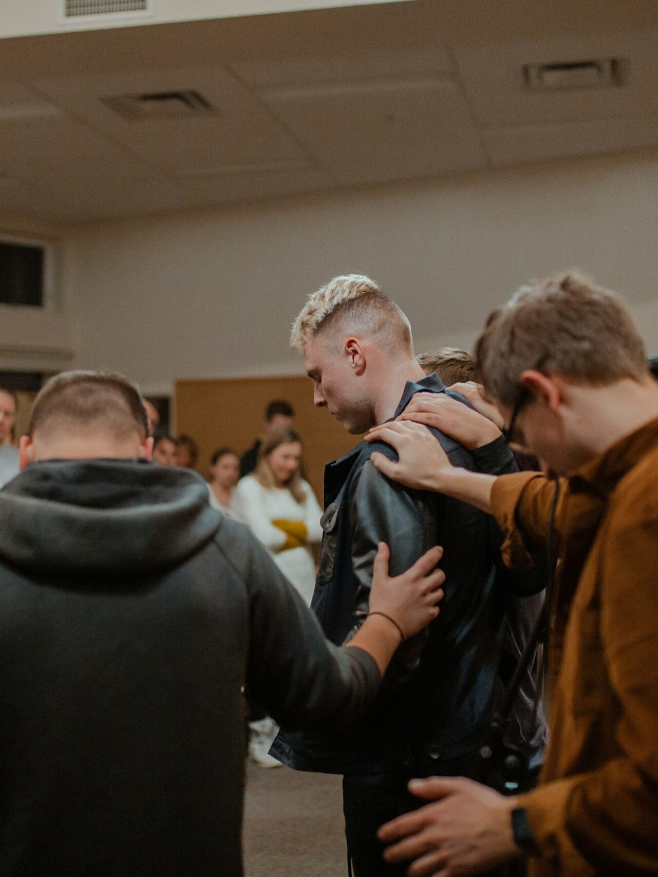 people in black and brown jackets standing in front of people