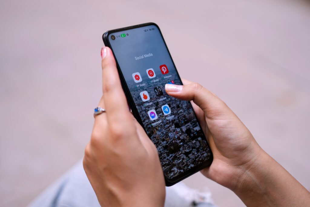 a woman holding a cell phone in her hand