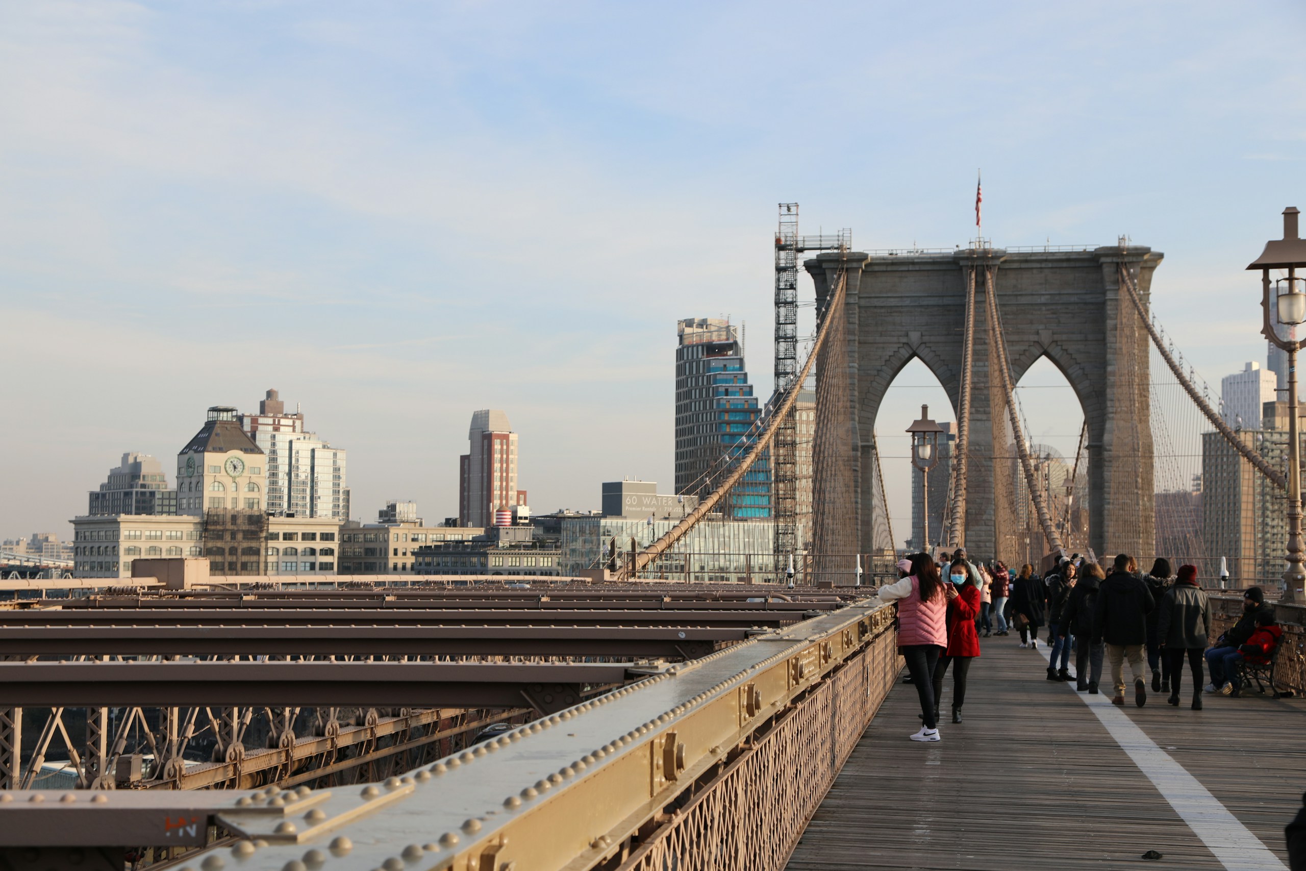 a group of people walking across a bridge