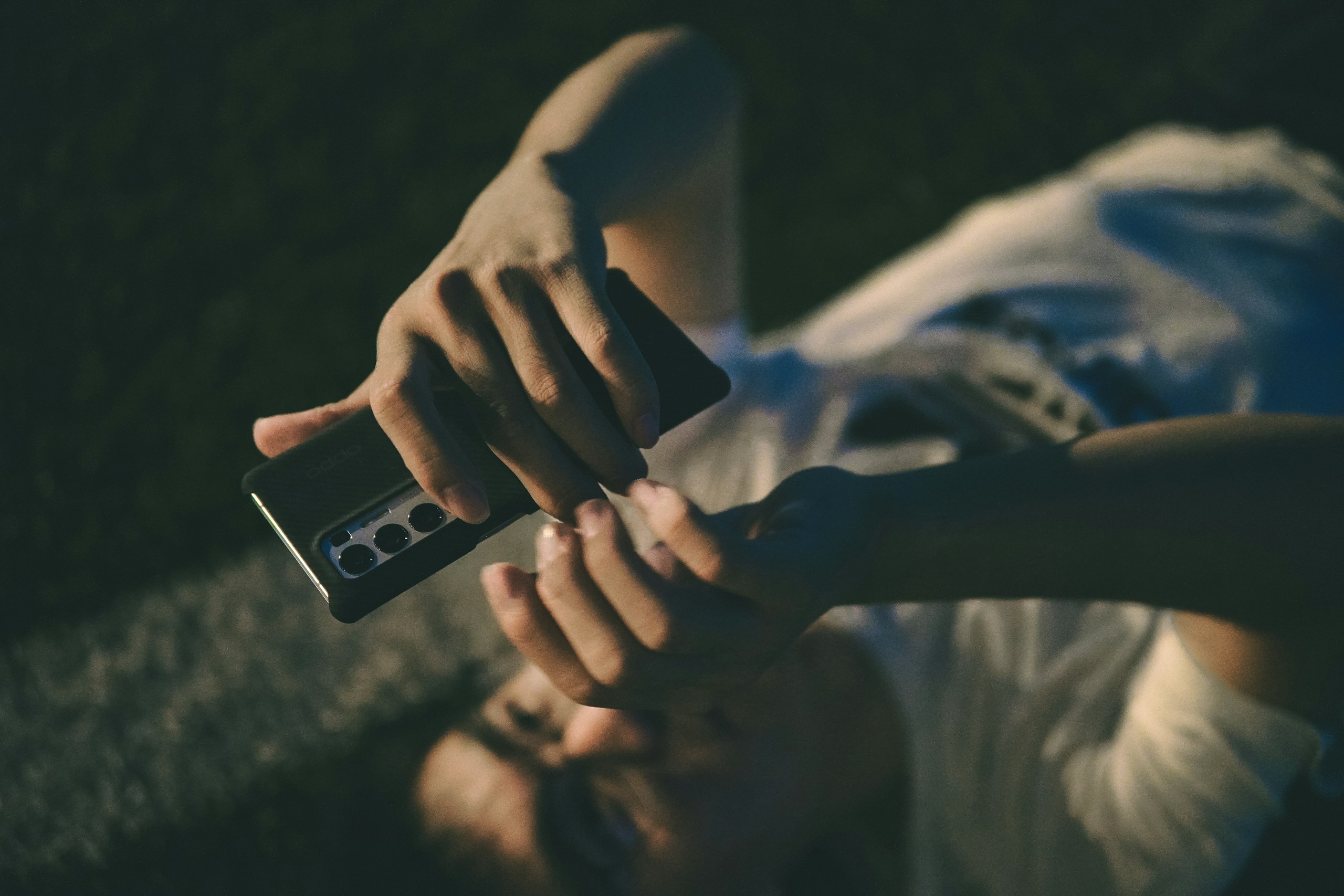 person holding iphone with black case