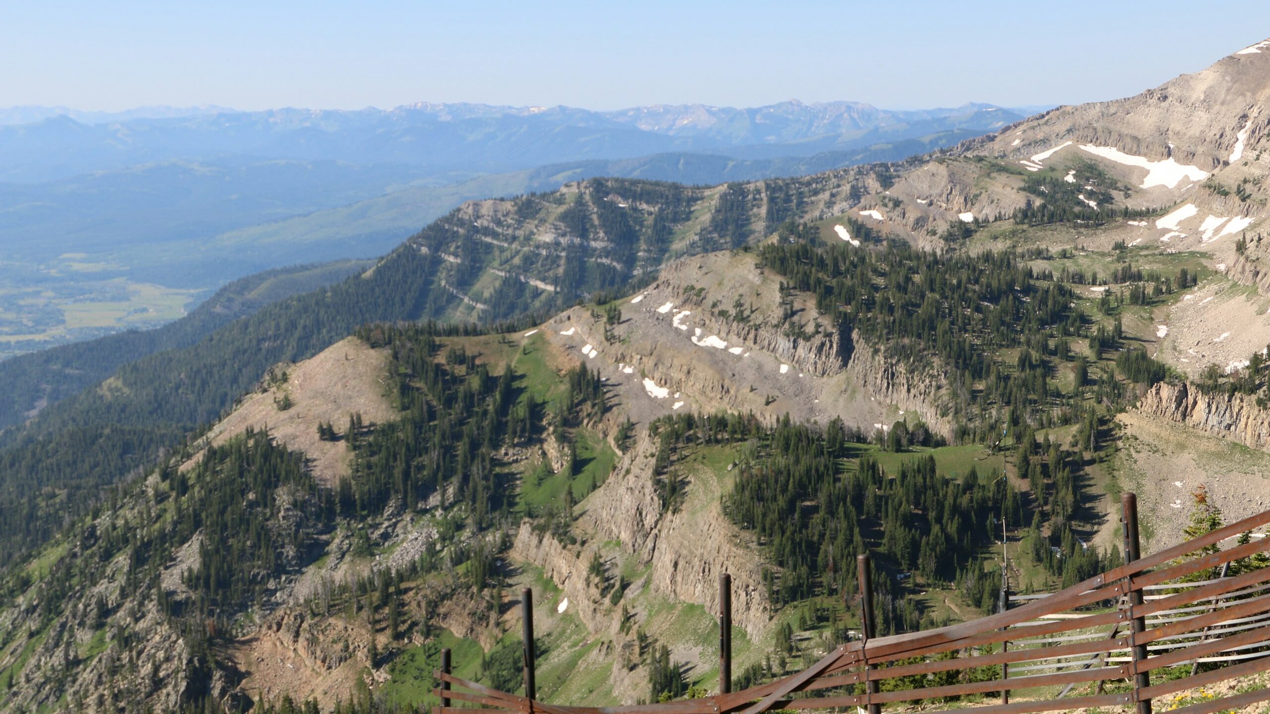 a wooden fence on the side of a mountain