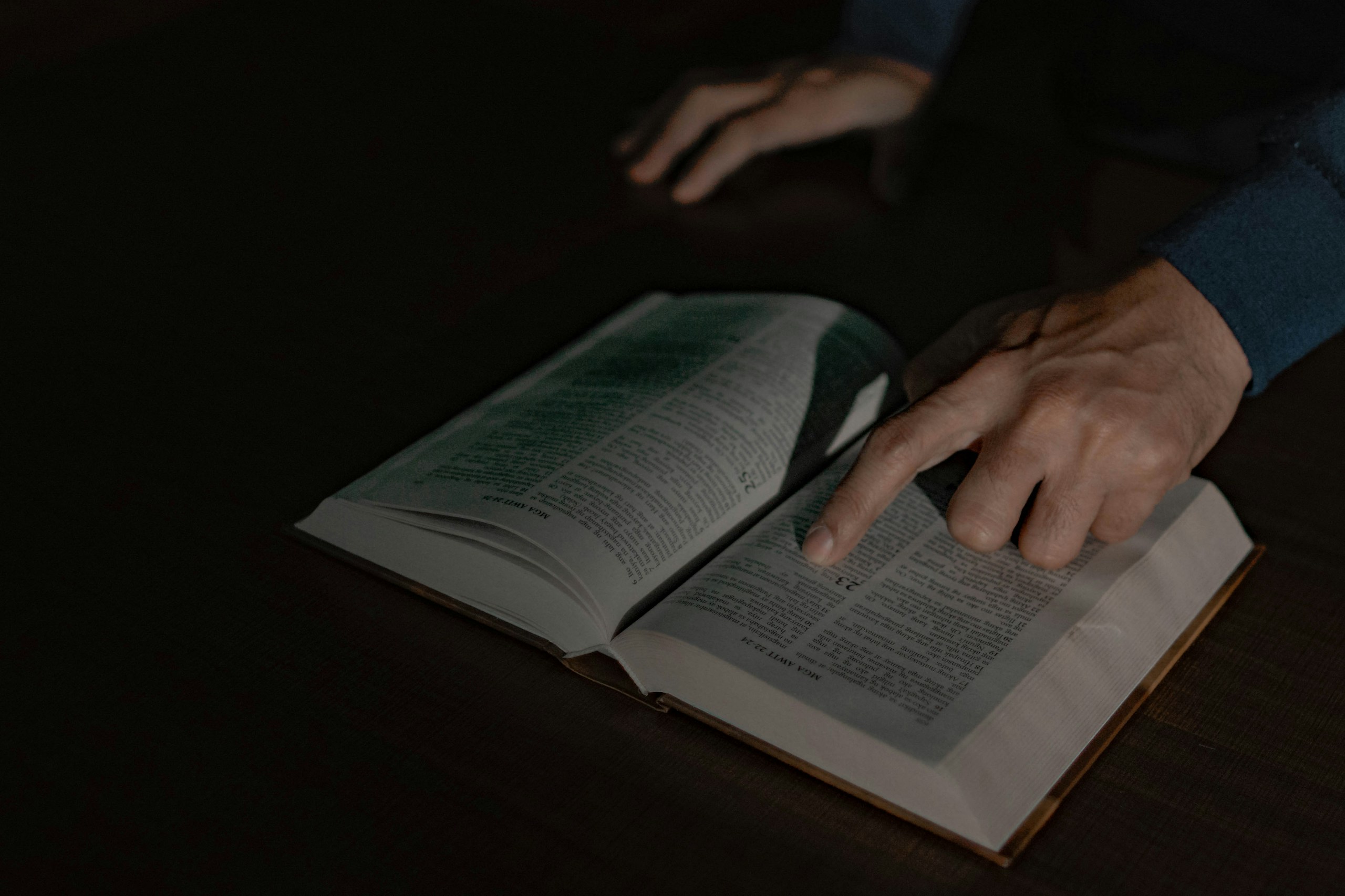 a person touching a book with their hand