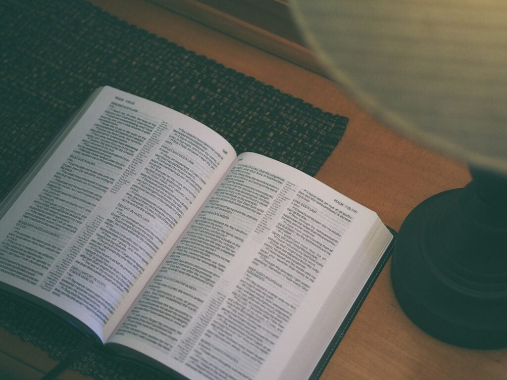 white book beside black table lamp