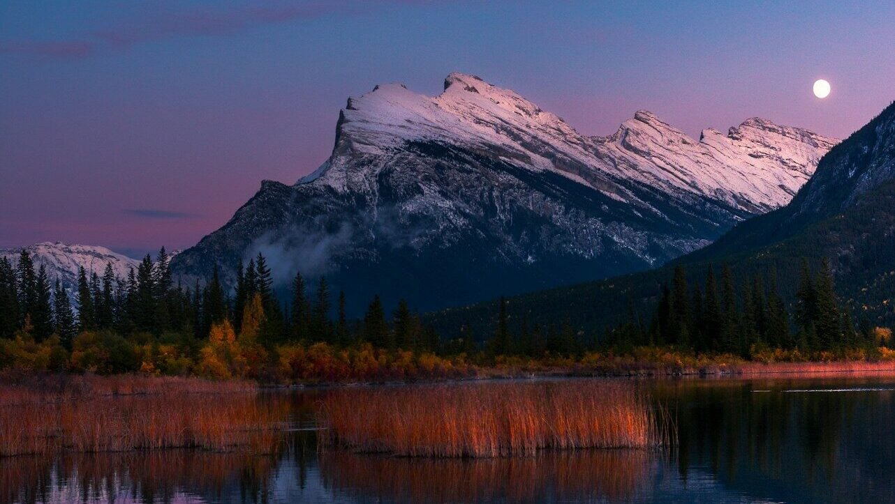 river beside mountain during golden hour