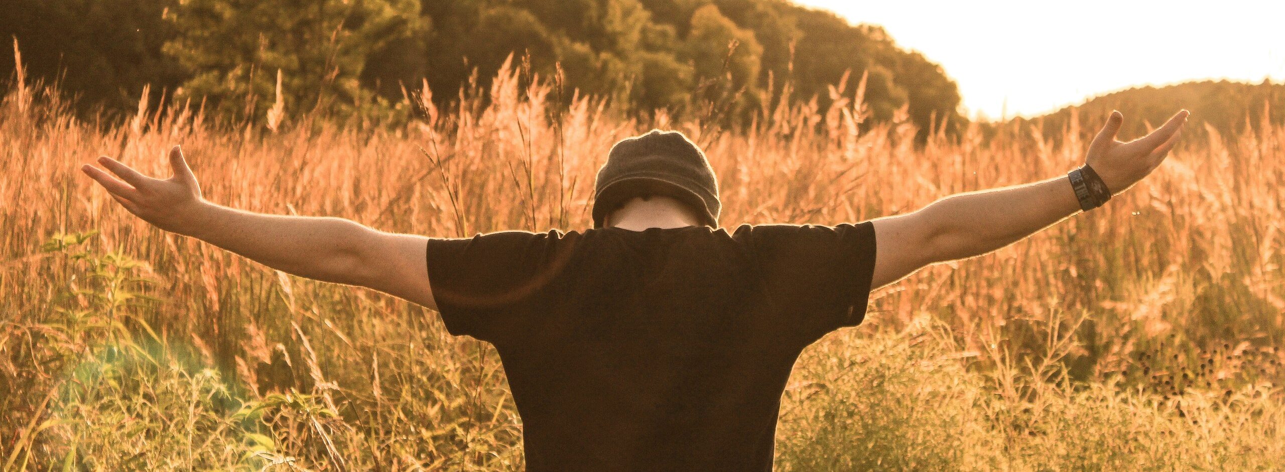 man standing in the middle of field