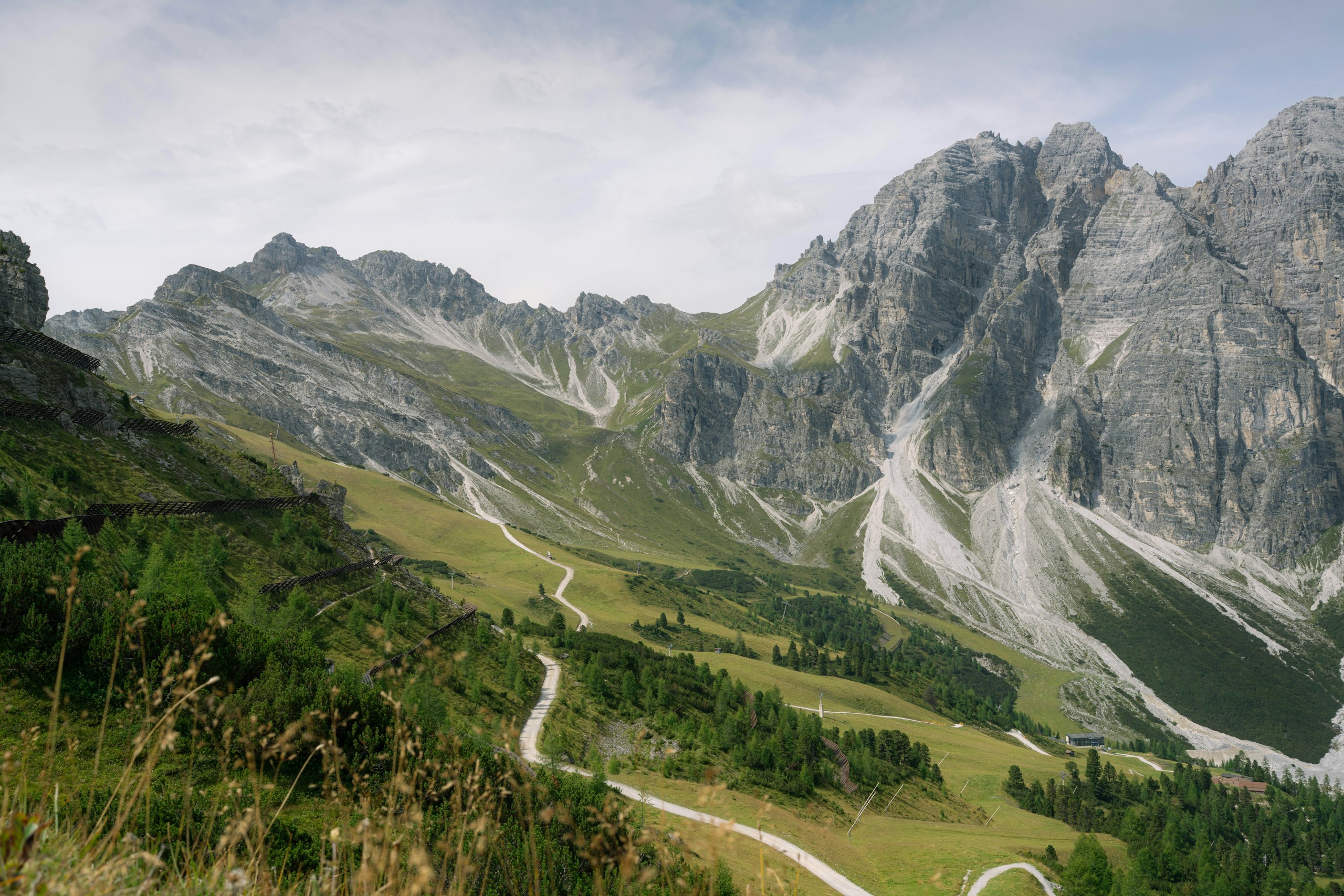 Winding path through a green mountain valley