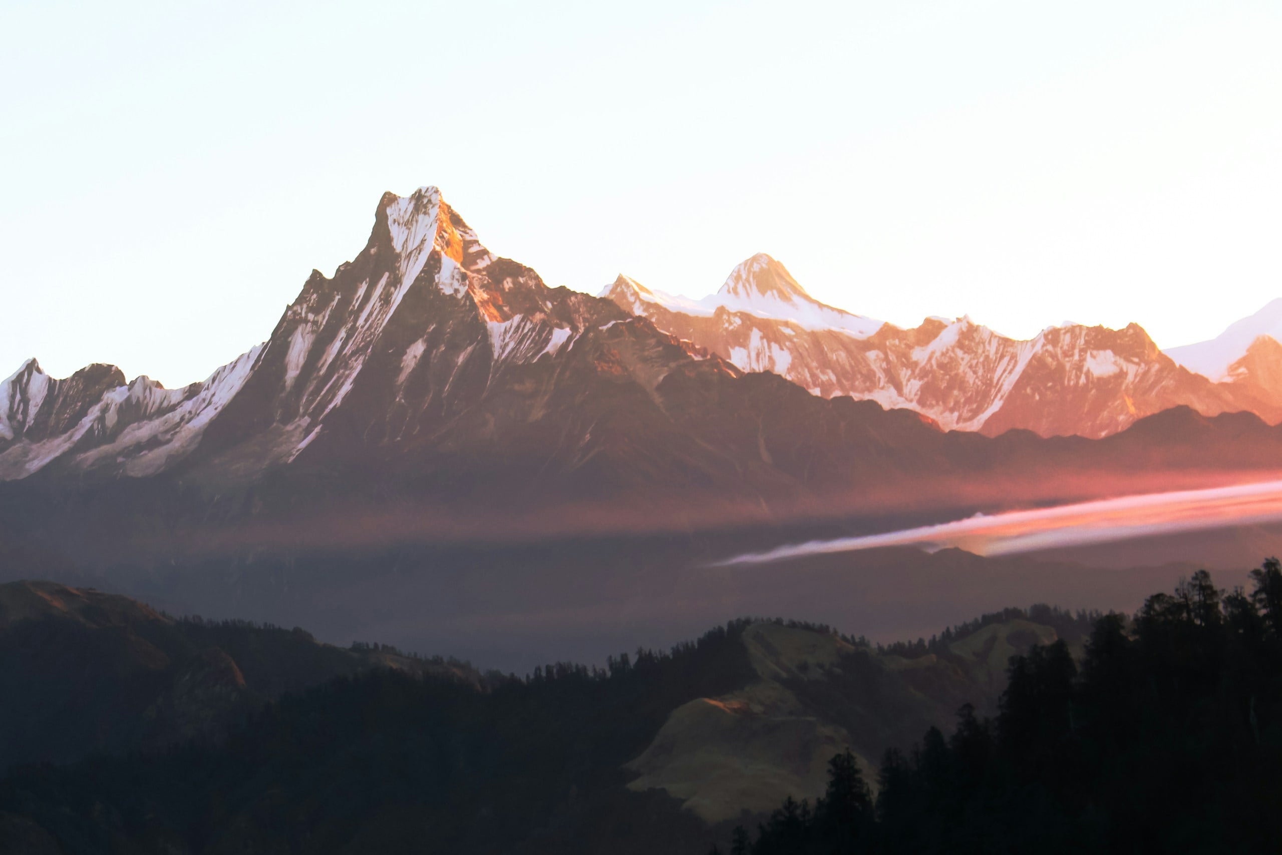 Majestic mountain peaks bathed in golden sunrise light.