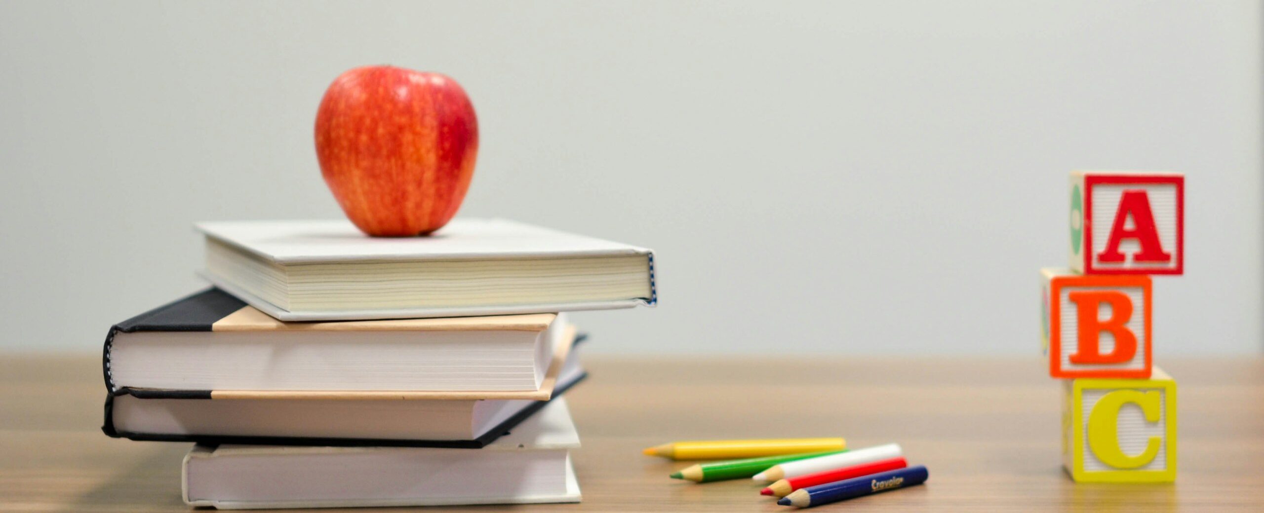 red apple fruit on four pyle books