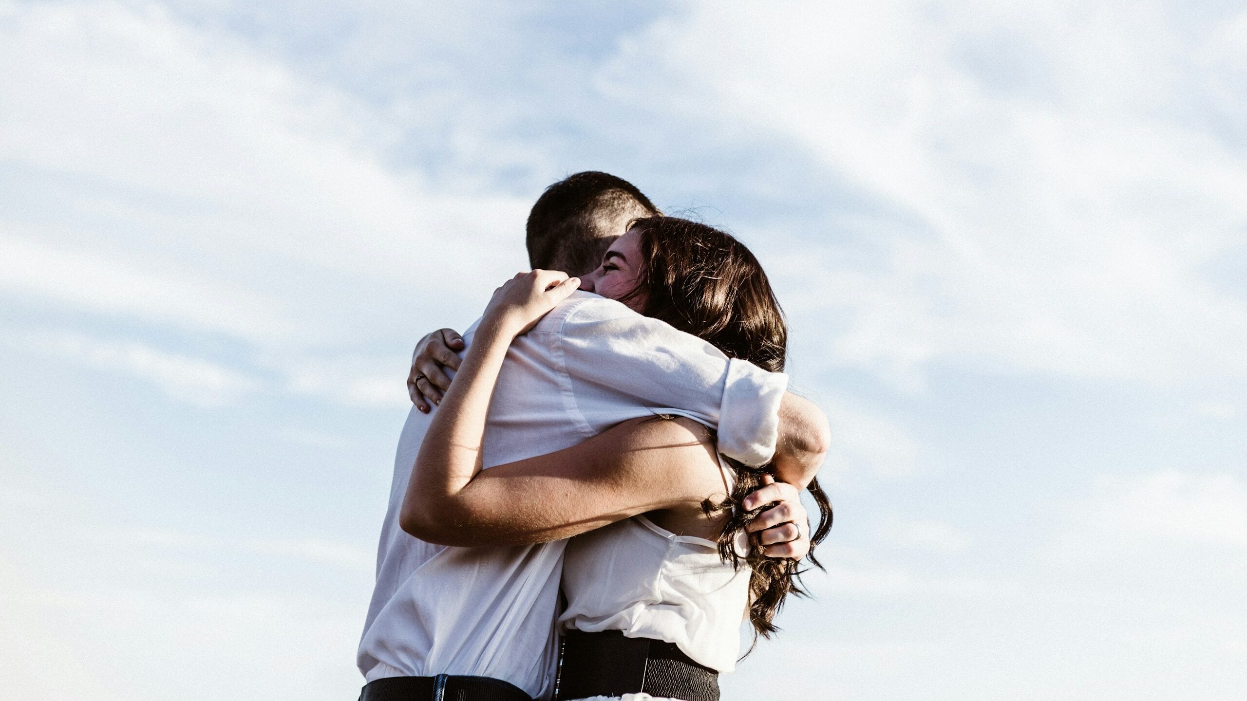 man and woman hugging each other photography