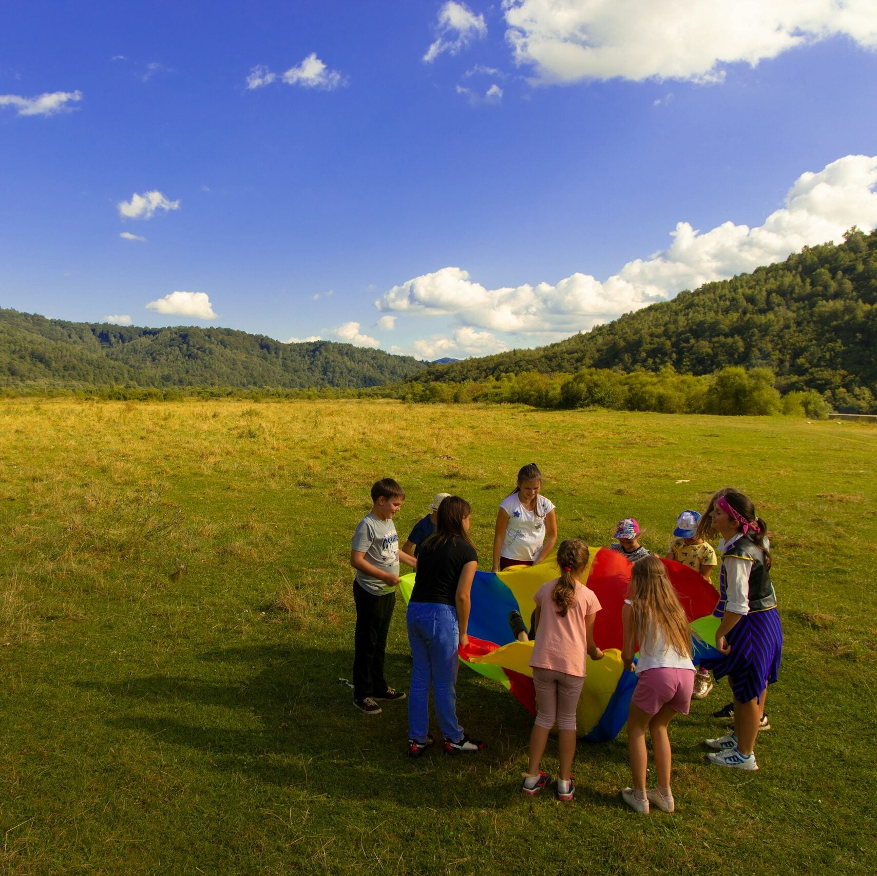 group of people standing on green grass field during daytime