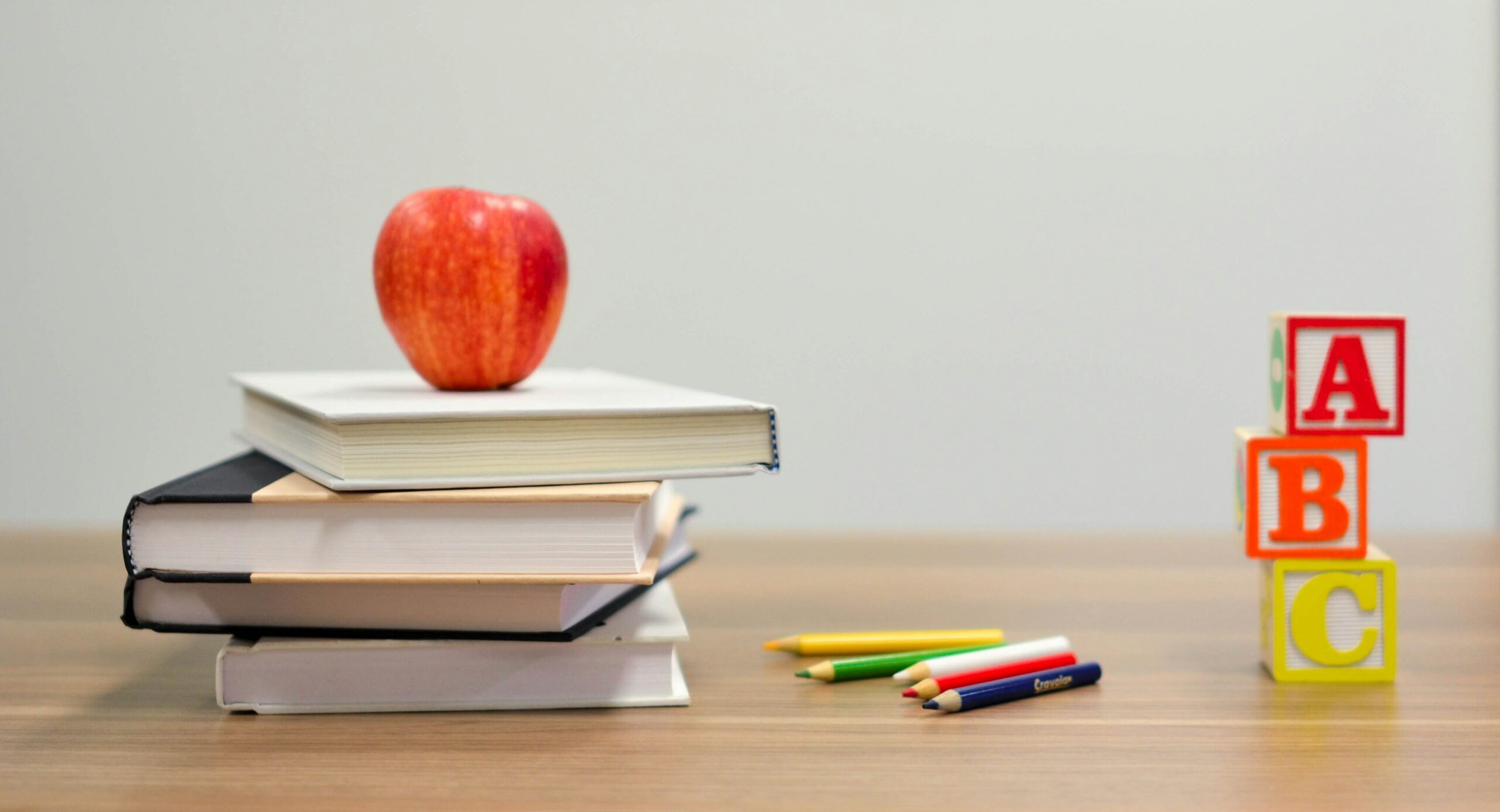red apple fruit on four pyle books