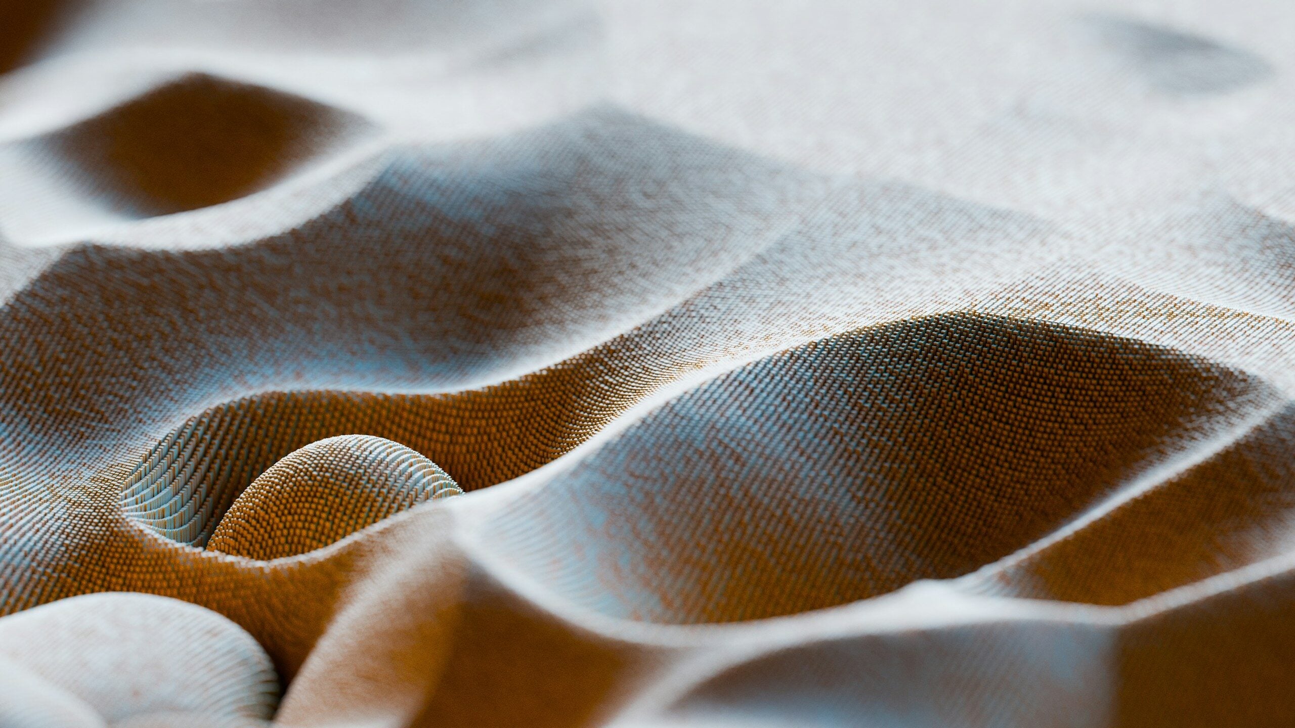 A textured surface with undulating waves and small, repeating geometric patterns in warm brown