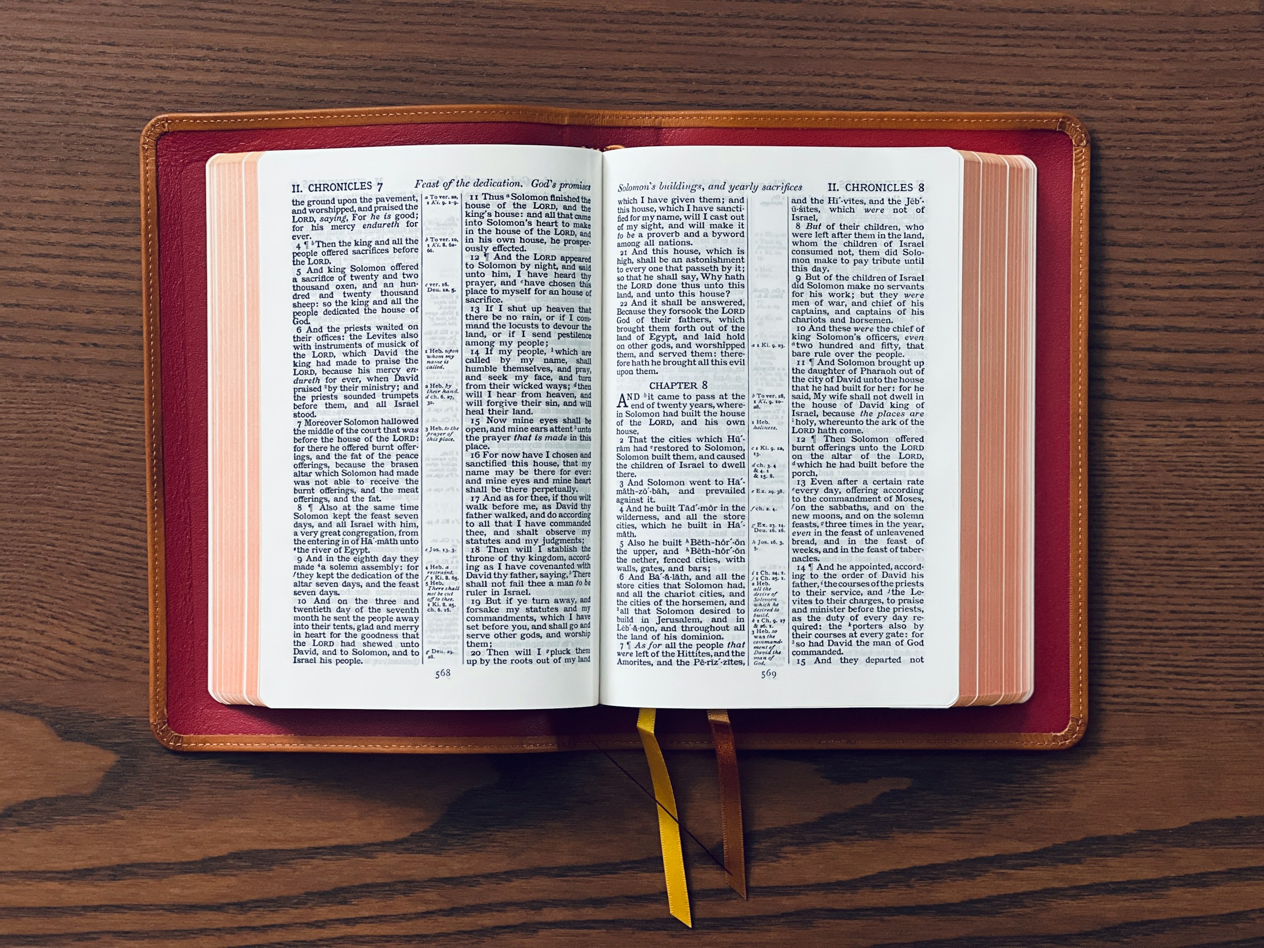 An open bible displays its text on the table.