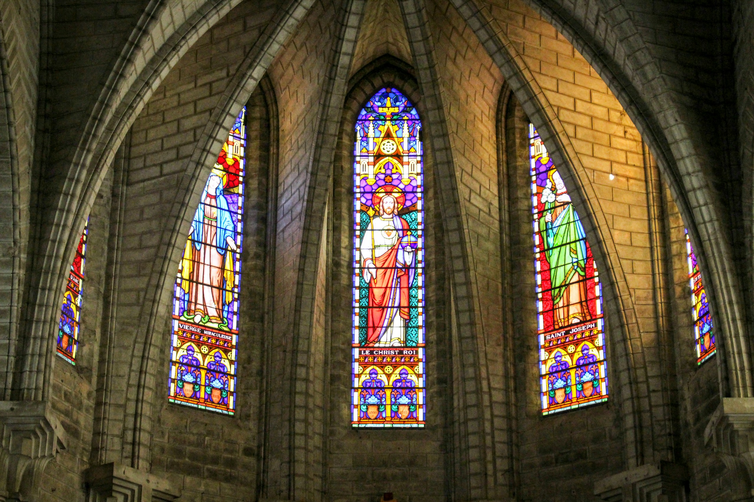 a man standing in front of a stained glass window
