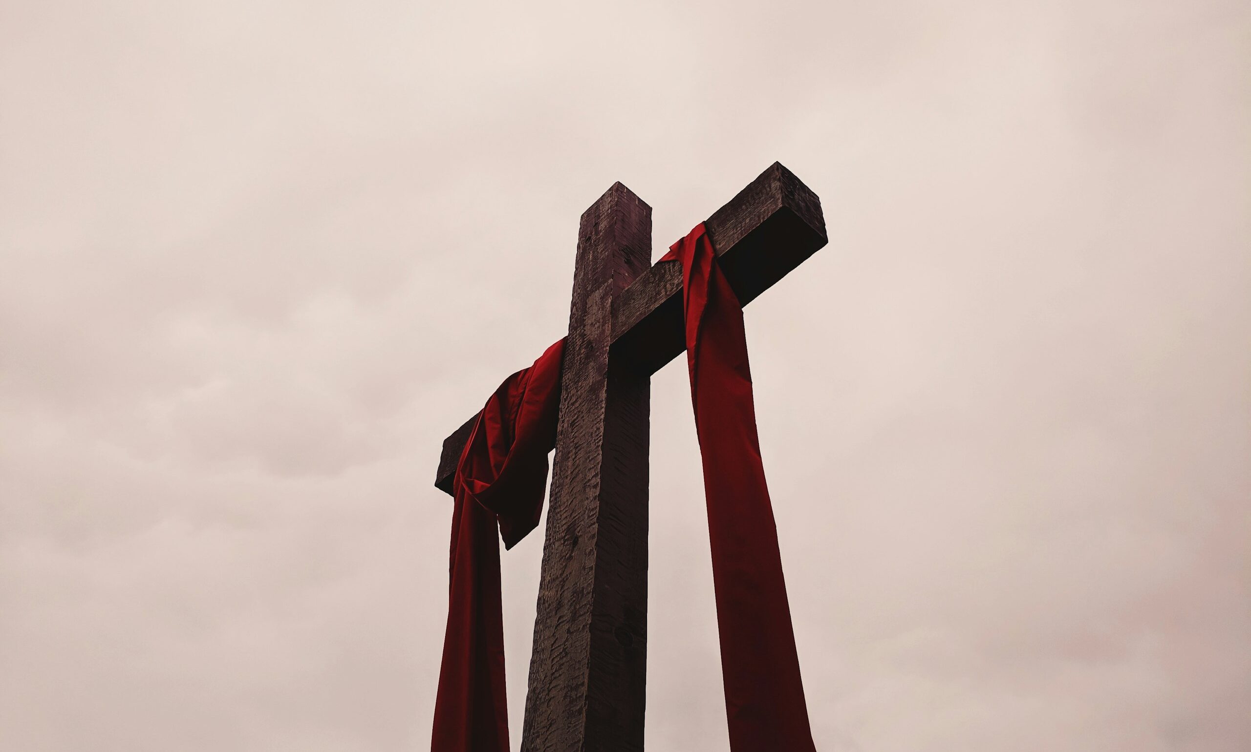 low angle view of cross with red garment