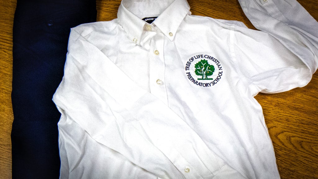 TLC Prep performance uniform white logo button-down shirt and navy pants
