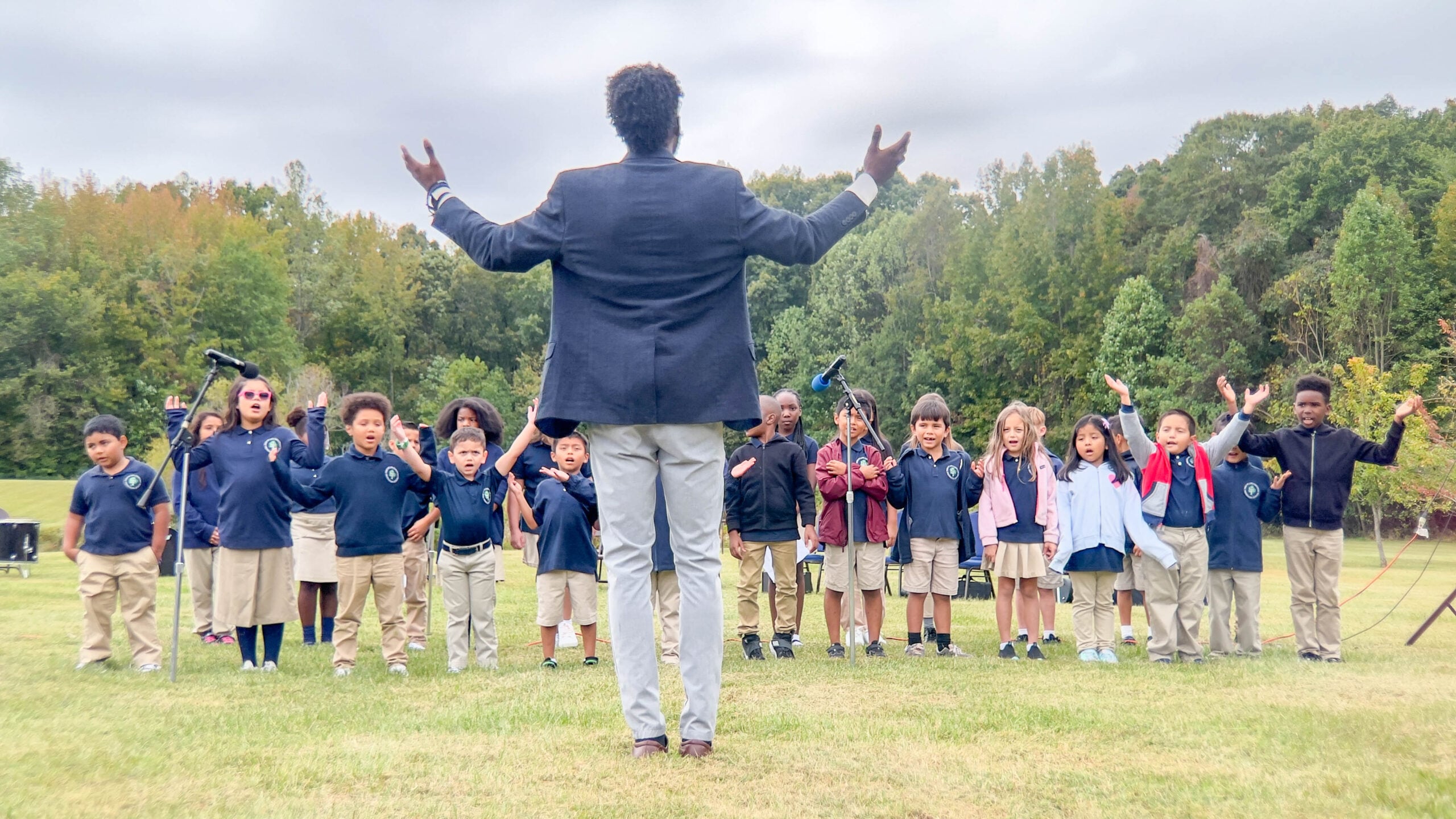 Children singing in a field