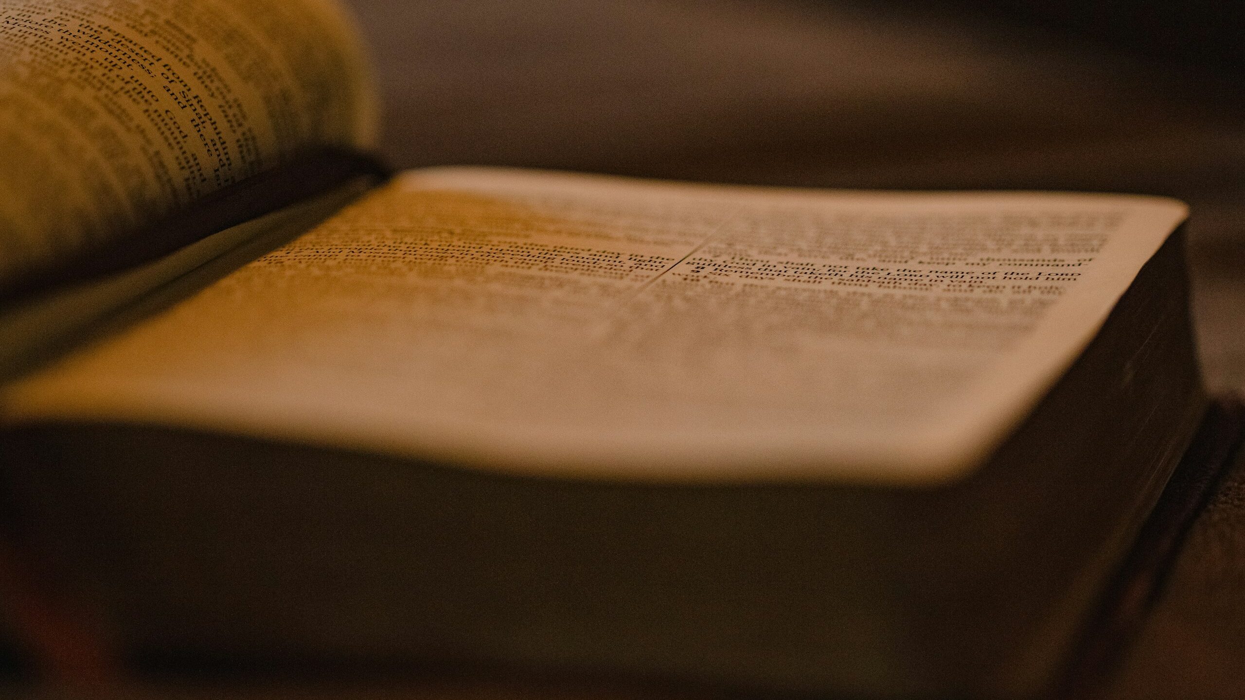 an open book sitting on top of a wooden table