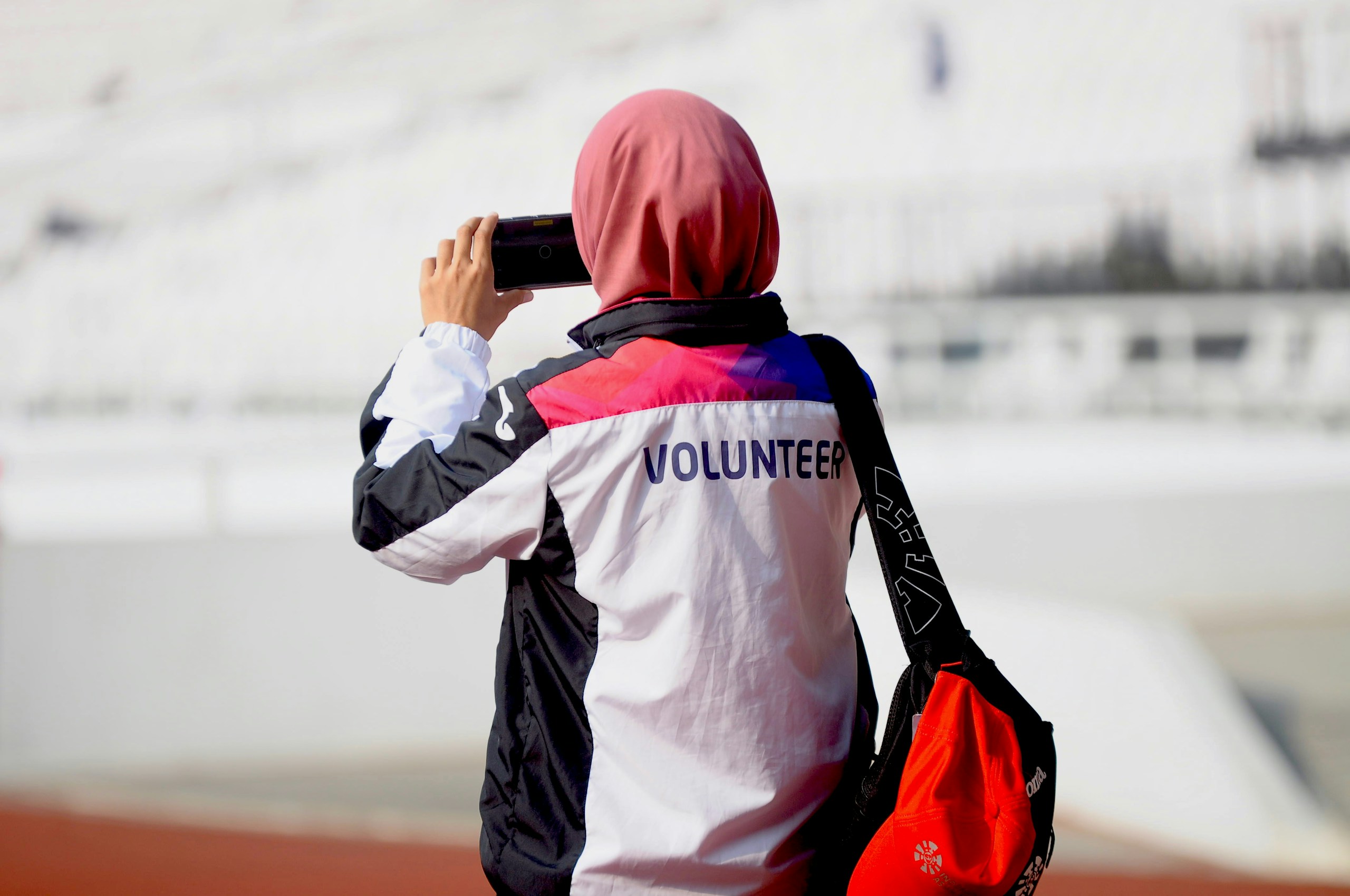 A woman taking a picture with her cell phone