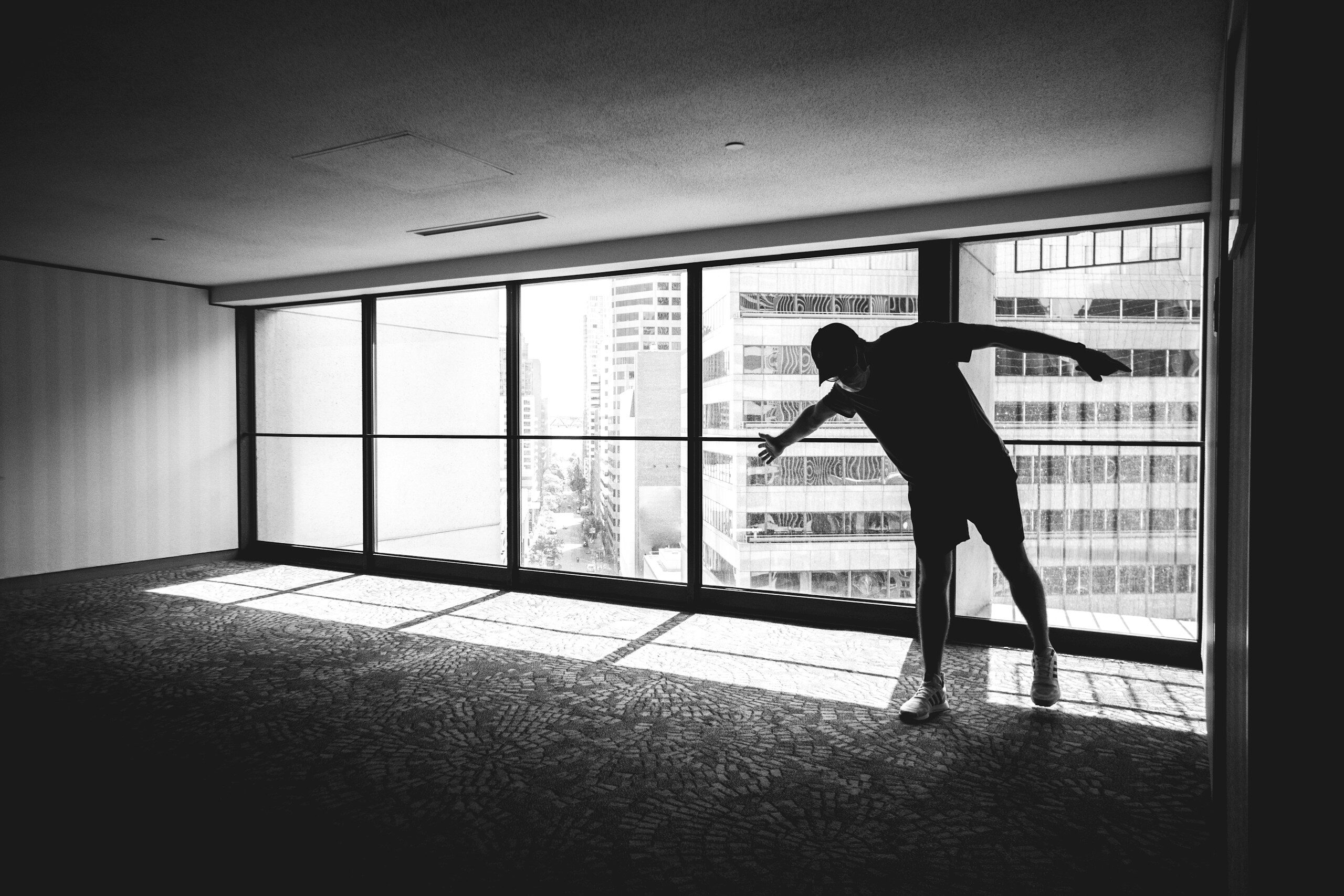 a person standing in front of a window in a room