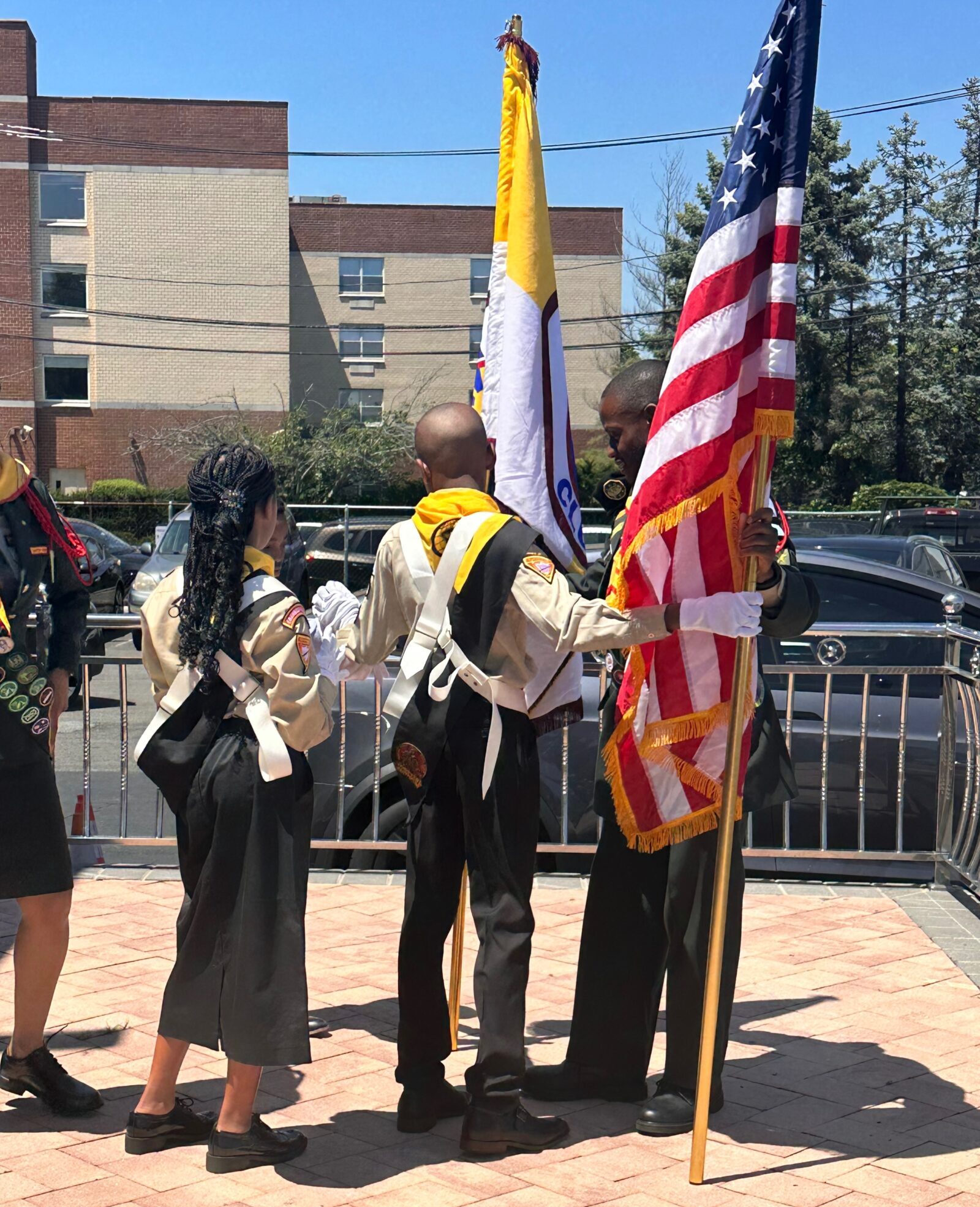 Adventurers holding the Adventurer and American flag at a church event.