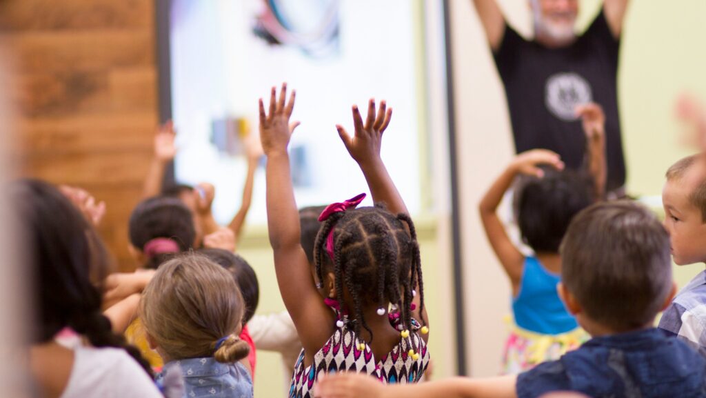 children lifting hands