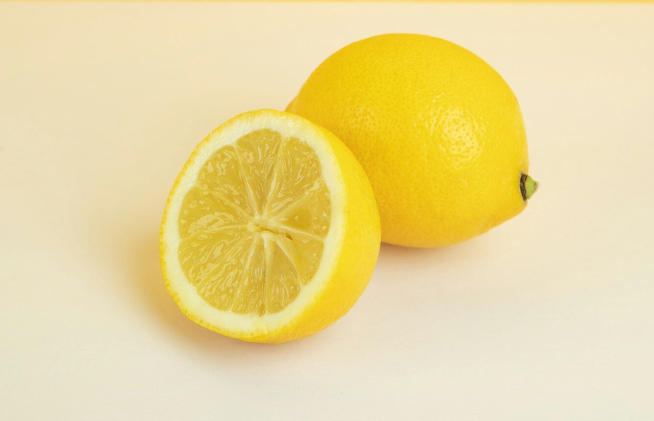 yellow lemon fruit on white surface