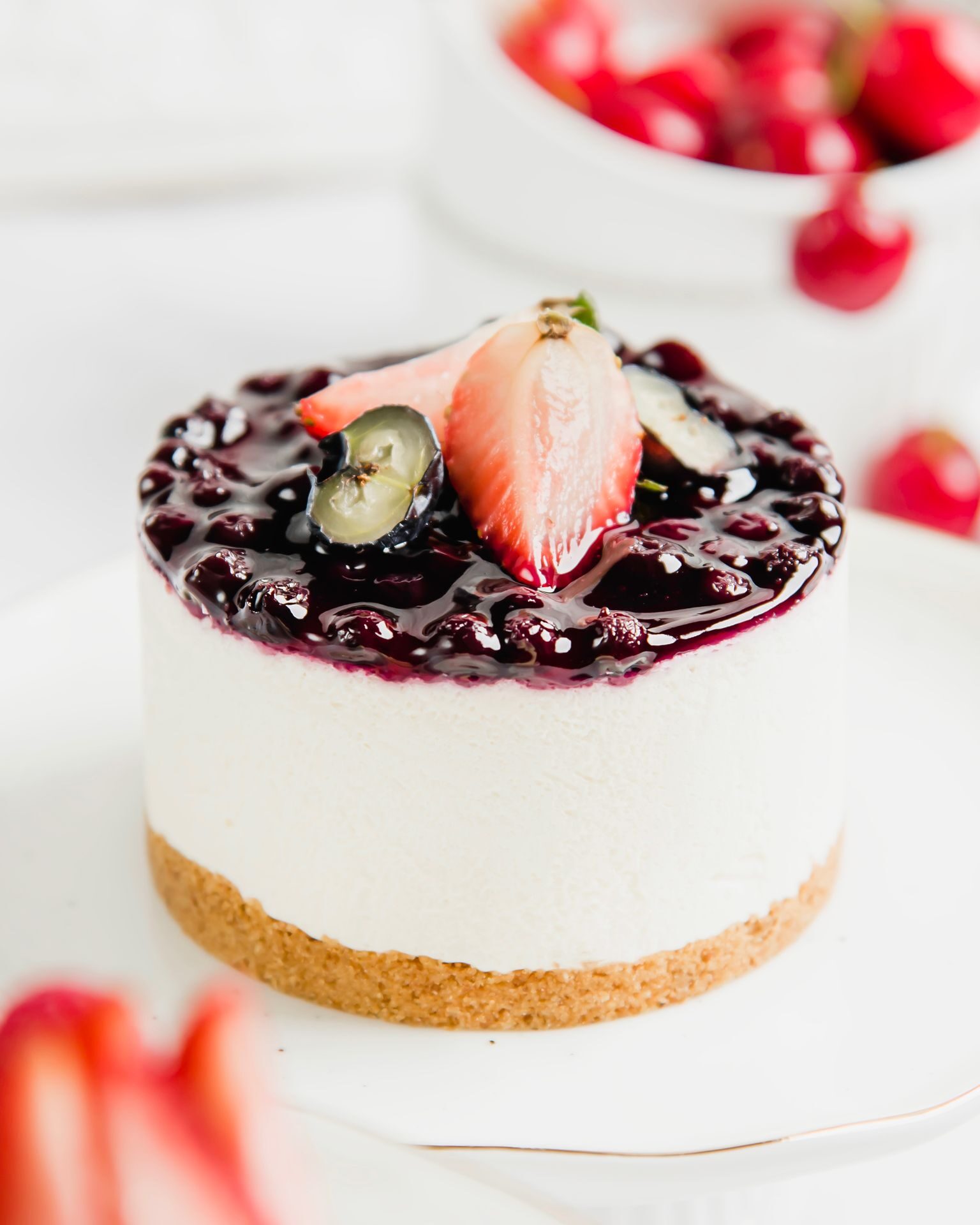 Close-up of a cheesecake topped with fresh berries, showcasing a creamy and delicious dessert.