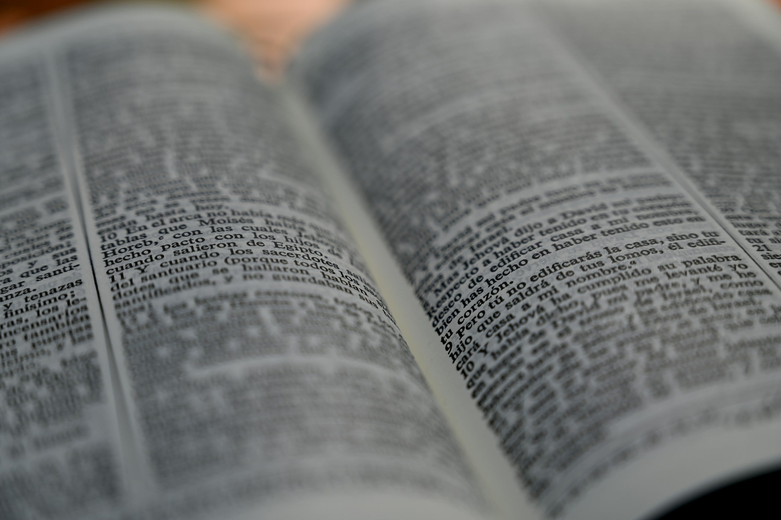 an open book sitting on top of a wooden table