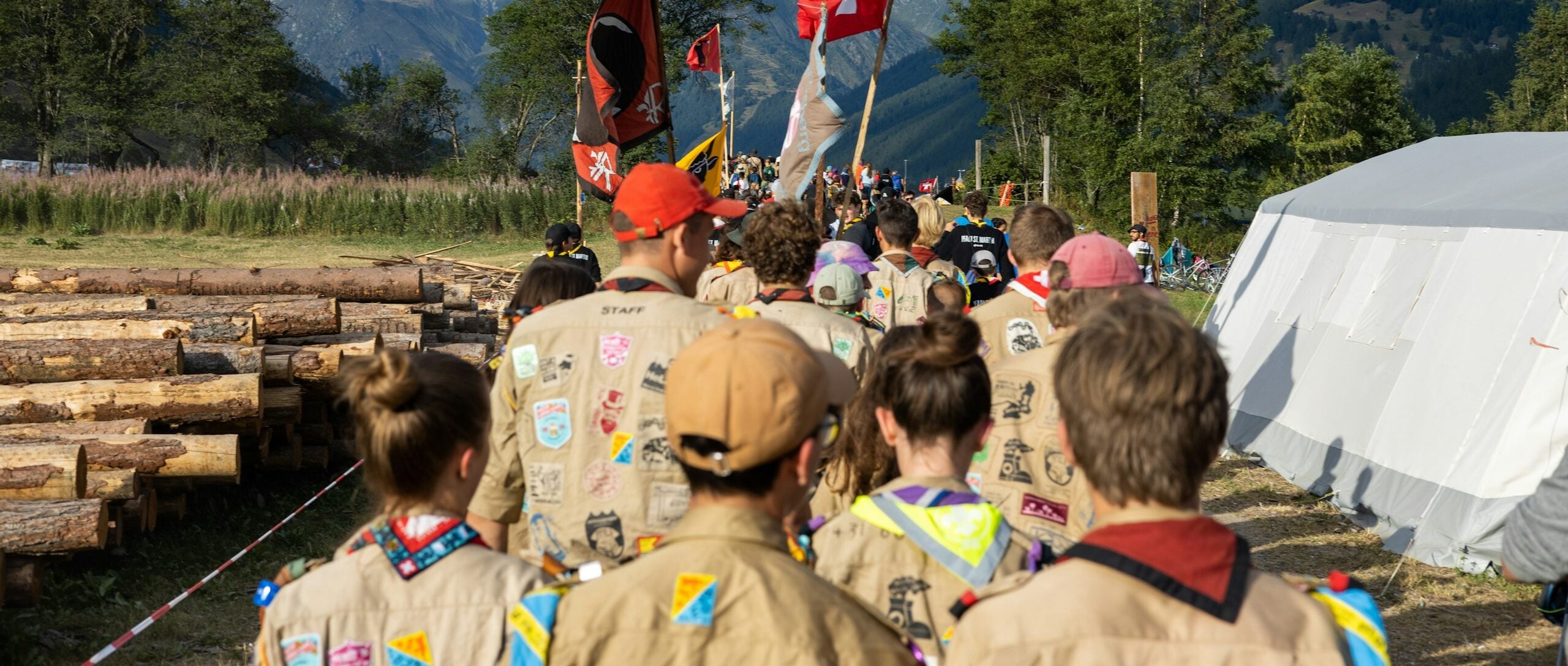 a group of people walking down a dirt road