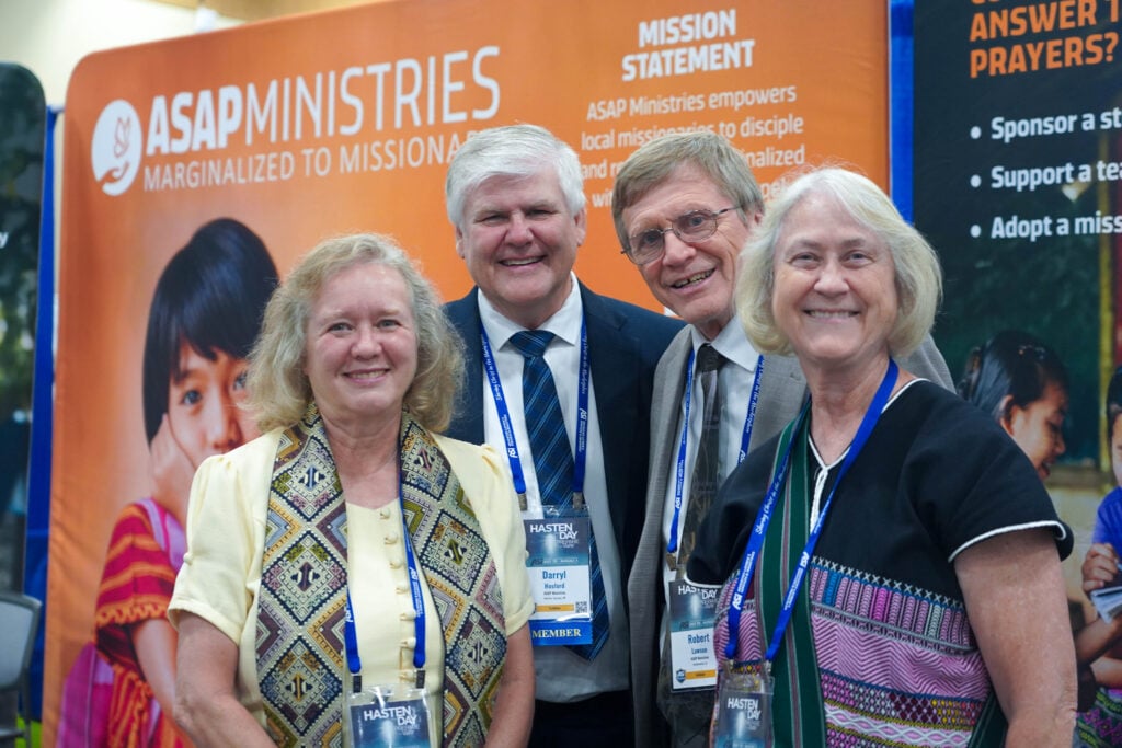Cheryl Hosford, Darryl Hosford, Robert Lawson and Carolanne Lawson stand together in front of the ASAP Ministries booth at ASI International 2026.