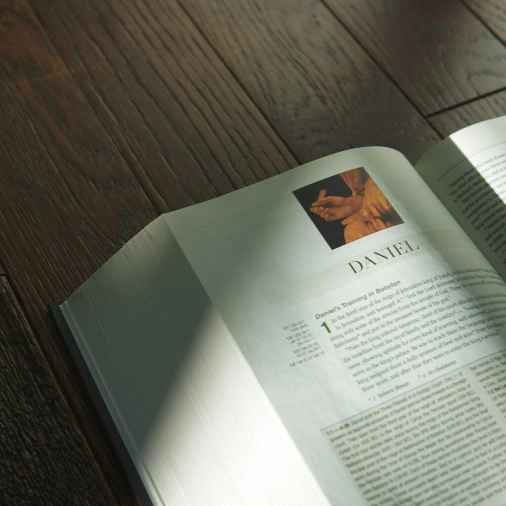 an open book sitting on top of a wooden table