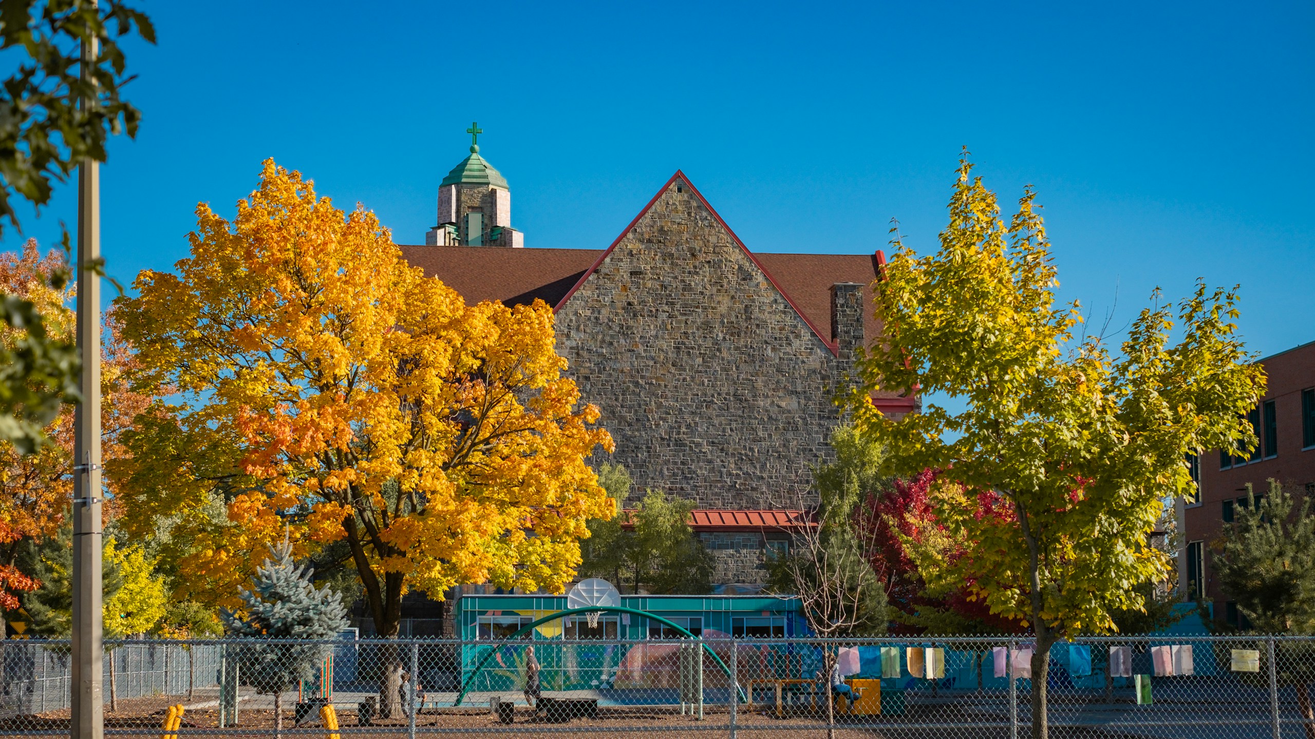 A fenced in area with a building in the background