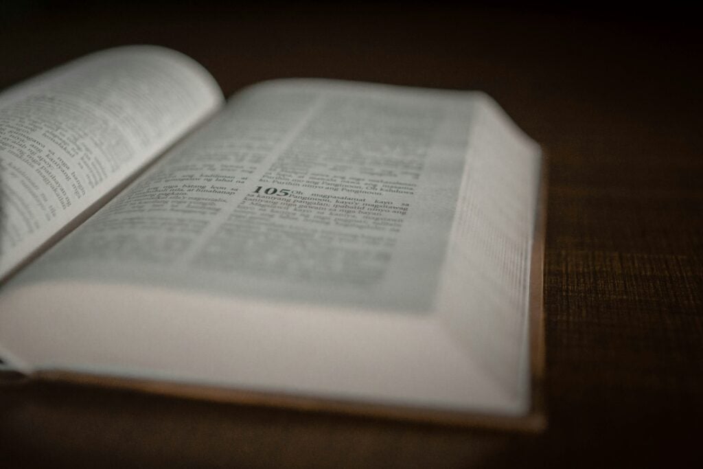 an open book sitting on top of a wooden table