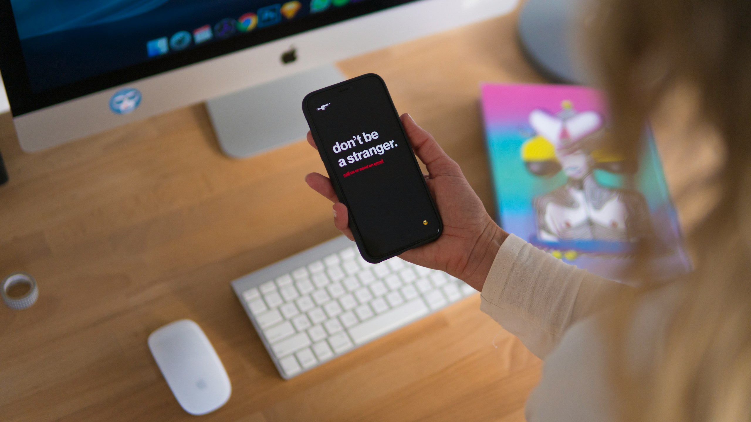 person holding black iPhone displaying don't be stranger