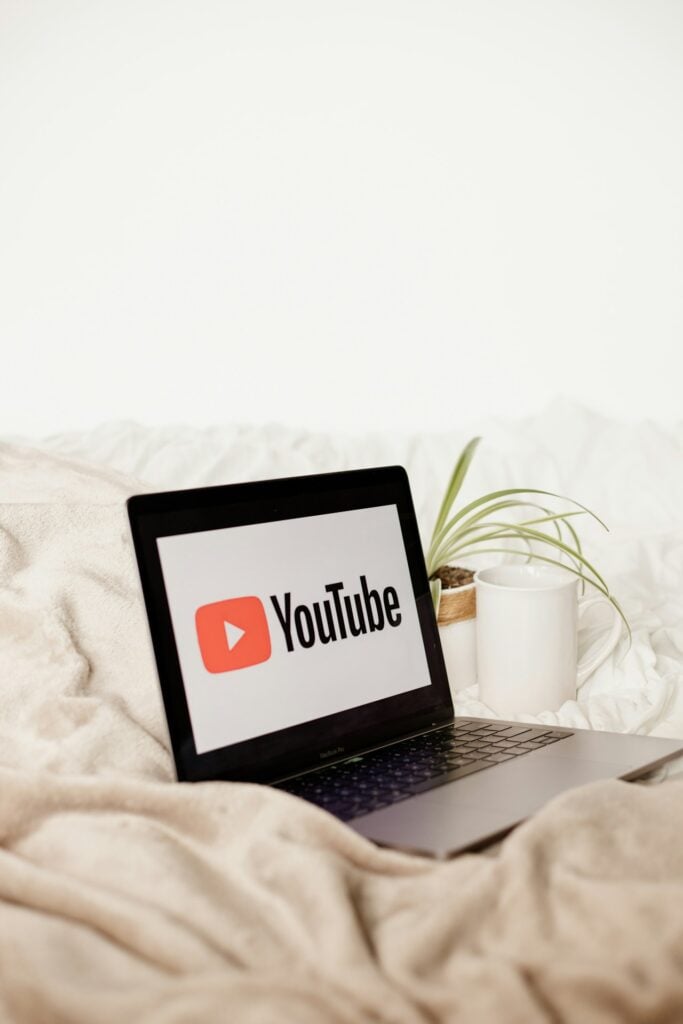 a laptop computer sitting on top of a bed