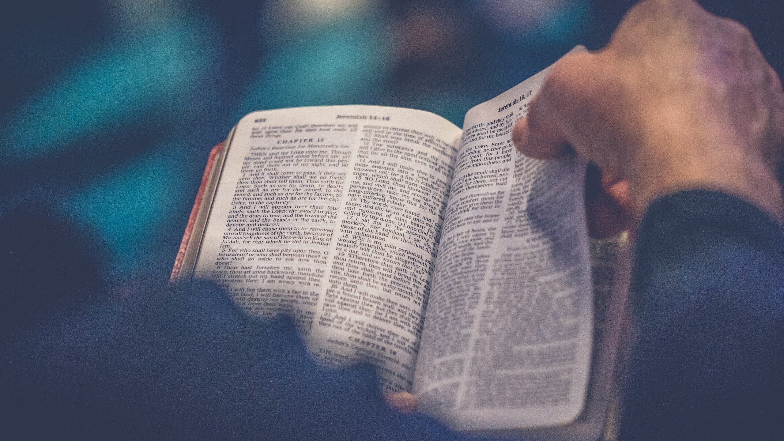 person's hand holding book page