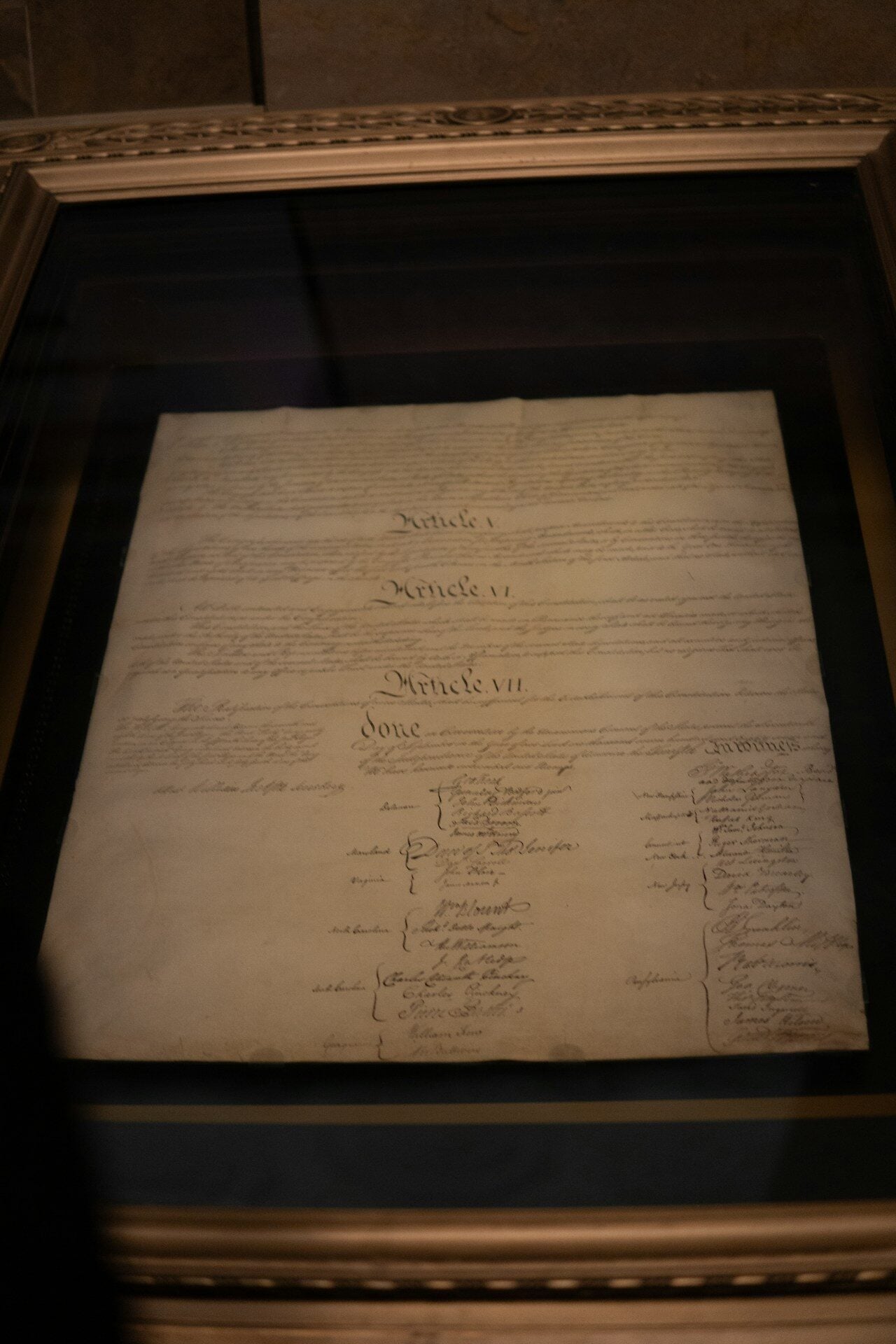 The u.s. constitution is framed and on display.