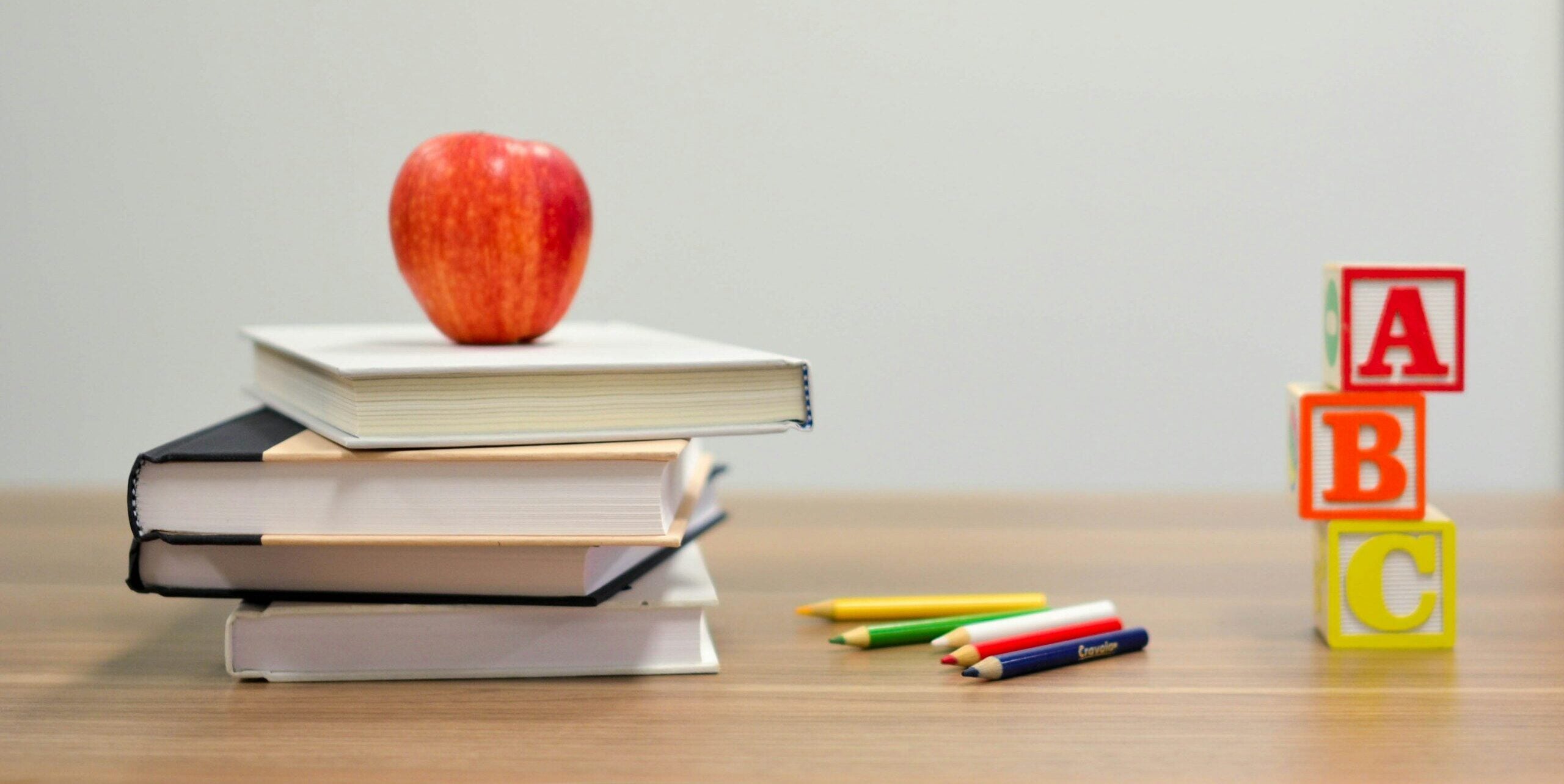 red apple fruit on four pyle books