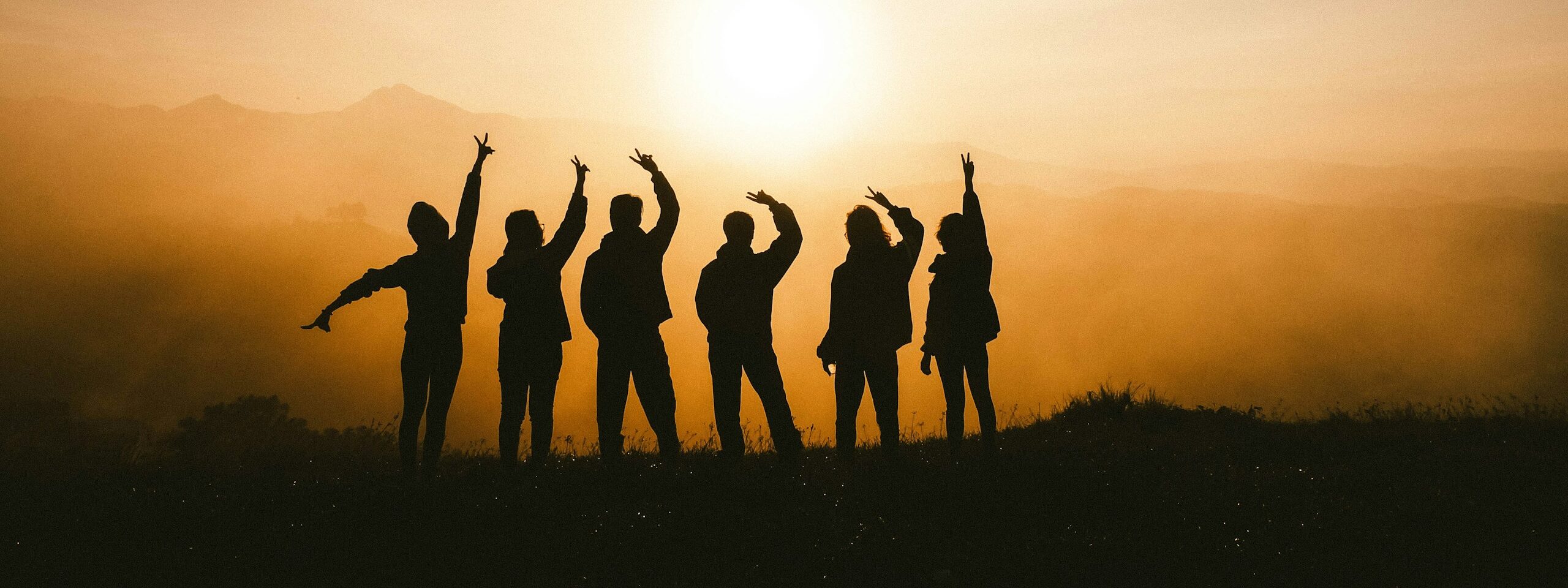 silhouette photo of six persons on top of mountain